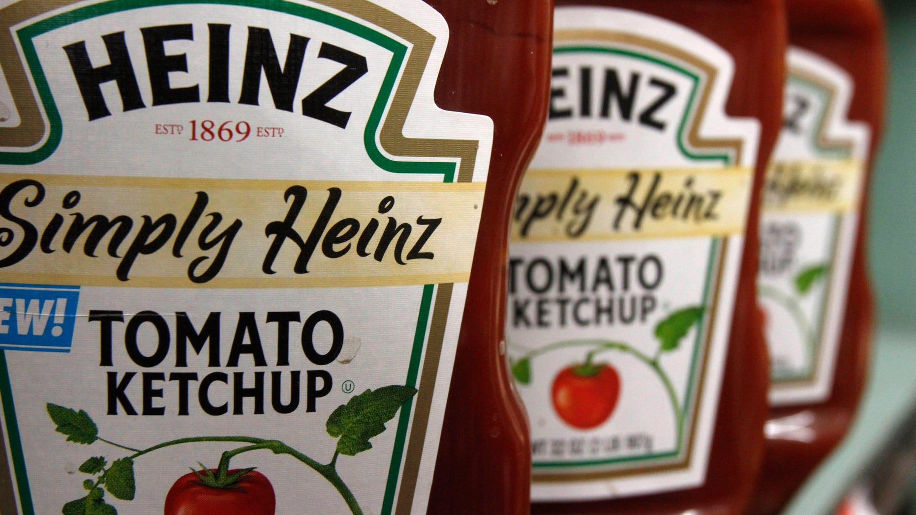 FILE - This Wednesday, March 2, 2011, file photo, shows containers of Heinz ketchup on the shelf of a market, in Barre, Vt. H.J. Heinz Co. is buying Kraft Foods Group Inc., creating what the companies say will be the third-largest food and beverage company in North America, the companies announced Wednesday, March 25, 2015. (AP Photo/Toby Talbot, File)