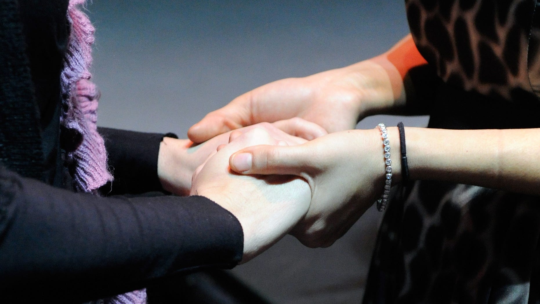 LAS VEGAS, NV - JANUARY 14: Celeste Flores Narvaez (R) holds hands with Natasha Bernasek, a dancer in the production show "Fantasy" after a memorial service for Narvaez's sister Debora Flores Narvaez at the Luxor Resort & Casino January 14, 2011 in Las Vegas, Nevada. Narvaez, who was last seen alive on December 12, 2010, was a dancer in the Luxor's "Fantasy" show. Police found her dismembered body on Saturday in two tubs filled with concrete in a house in downtown Las Vegas. Her ex-boyfriend Jason "Blu" Griffith has been charged with murder, felony battery constituting domestic violence (strangulation) and destroying evidence in connection with her murder. (Photo by Ethan Miller/Getty Images)