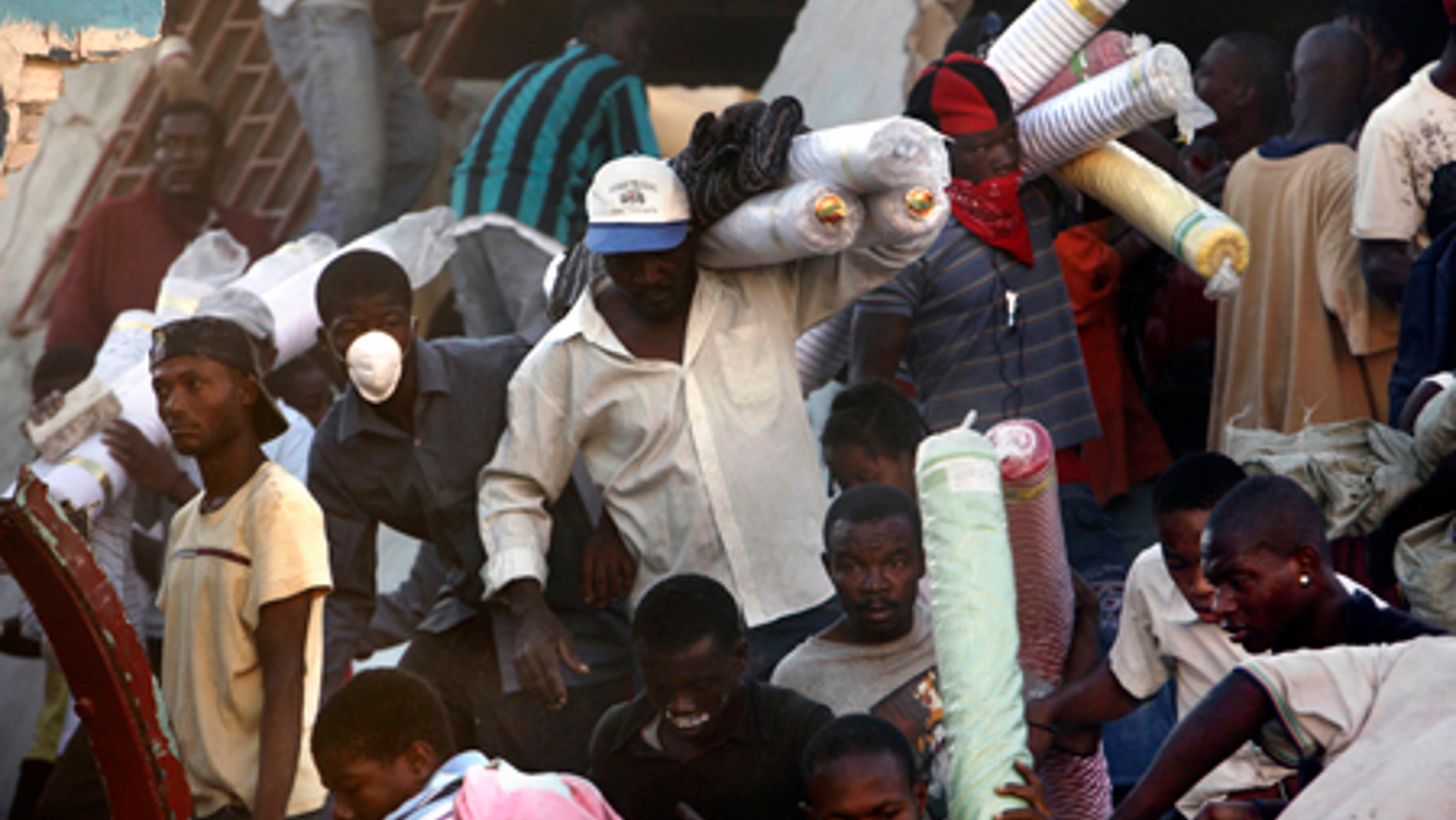 Jan. 16: People take goods from a collapsed store in Port-au-Prince.