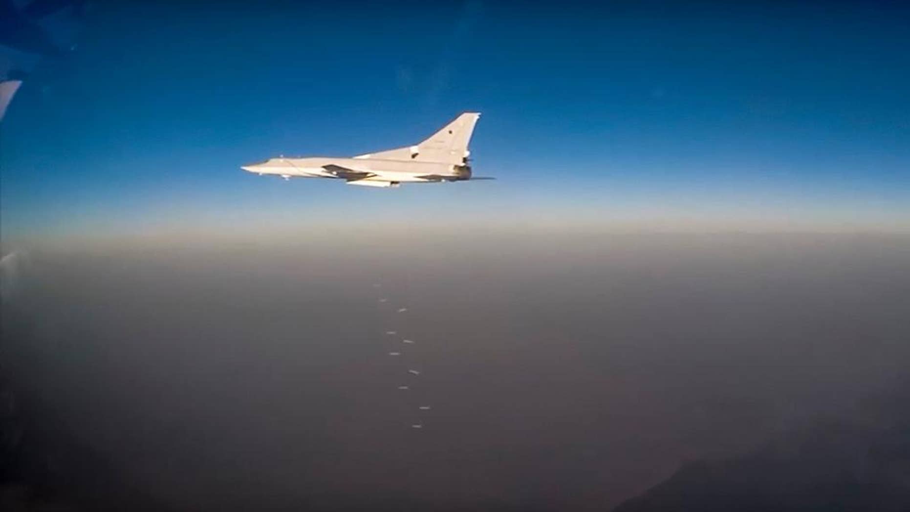 In this frame grab provided by Russian Defence Ministry press service Russian long range bomber Tu-22M3 flies during an air strike over Syria on Thursday, Aug. 18, 2016. Russia's Defence Ministry said on Tuesday Russian warplanes have taken off from a base in Iran and in Russia to target Islamic State fighters in Syria. (Russian Defence Ministry Press Service photo via AP)