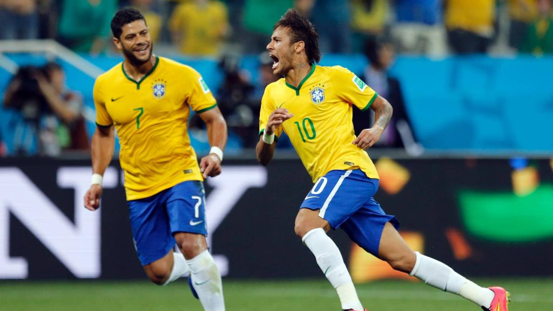 Brazil's Neymar, right, celebrates with teammate Hulk after scoring during the group A World Cup soccer match against Croatia in the opening game of the tournament at Itaquerao Stadium in Sao Paulo, Brazil, Thursday, June 12, 2014. (AP Photo/Frank Augstein)