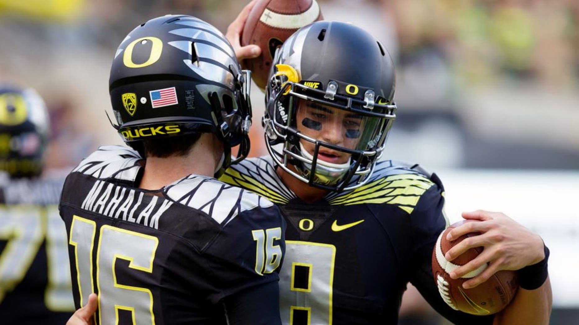 Nov 1, 2014; Eugene, OR, USA; Oregon Ducks quarterback Morgan Mahalak (16) and quarterback Marcus Mariota (8) talk before the game against the Stanford Cardinal at Autzen Stadium. Mandatory Credit: Scott Olmos-USA TODAY Sports