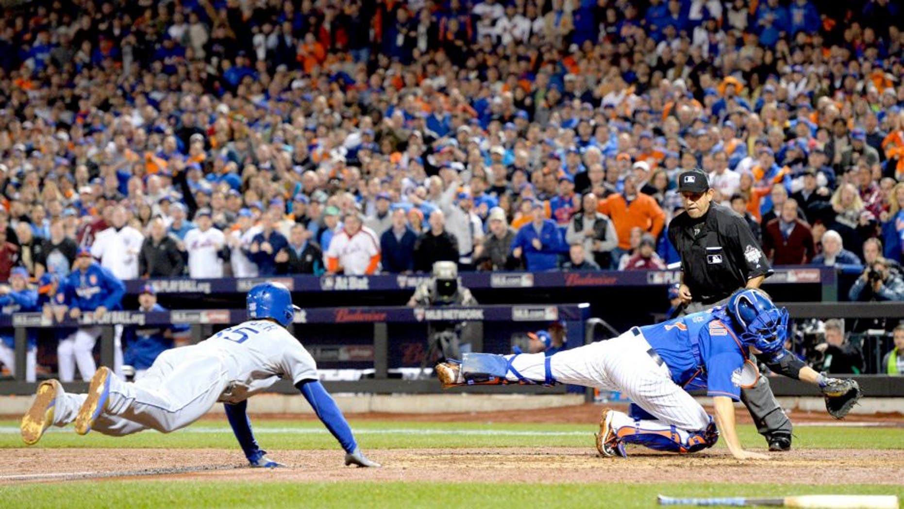 Nov 1, 2015; New York City, NY, USA; Kansas City Royals first baseman Eric Hosmer (35) scores the tying run past New York Mets catcher Travis d'Arnaud (7) in the 9th inning in game five of the World Series at Citi Field. Mandatory Credit: Robert Deutsch-USA TODAY Sports