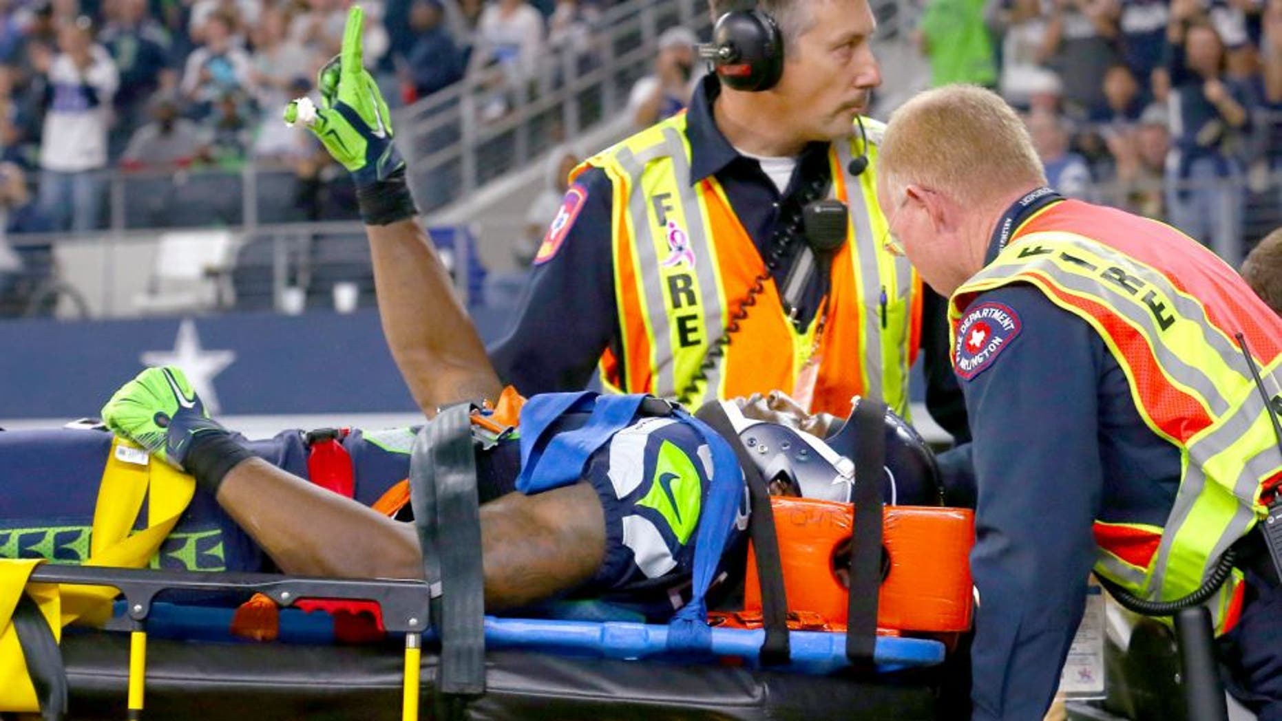 ARLINGTON, TX - NOVEMBER 01: Ricardo Lockette #83 of the Seattle Seahawks waves to fans while being carted off the field in the second quarter at AT&T Stadium on November 1, 2015 in Arlington, Texas. (Photo by Tom Pennington/Getty Images)