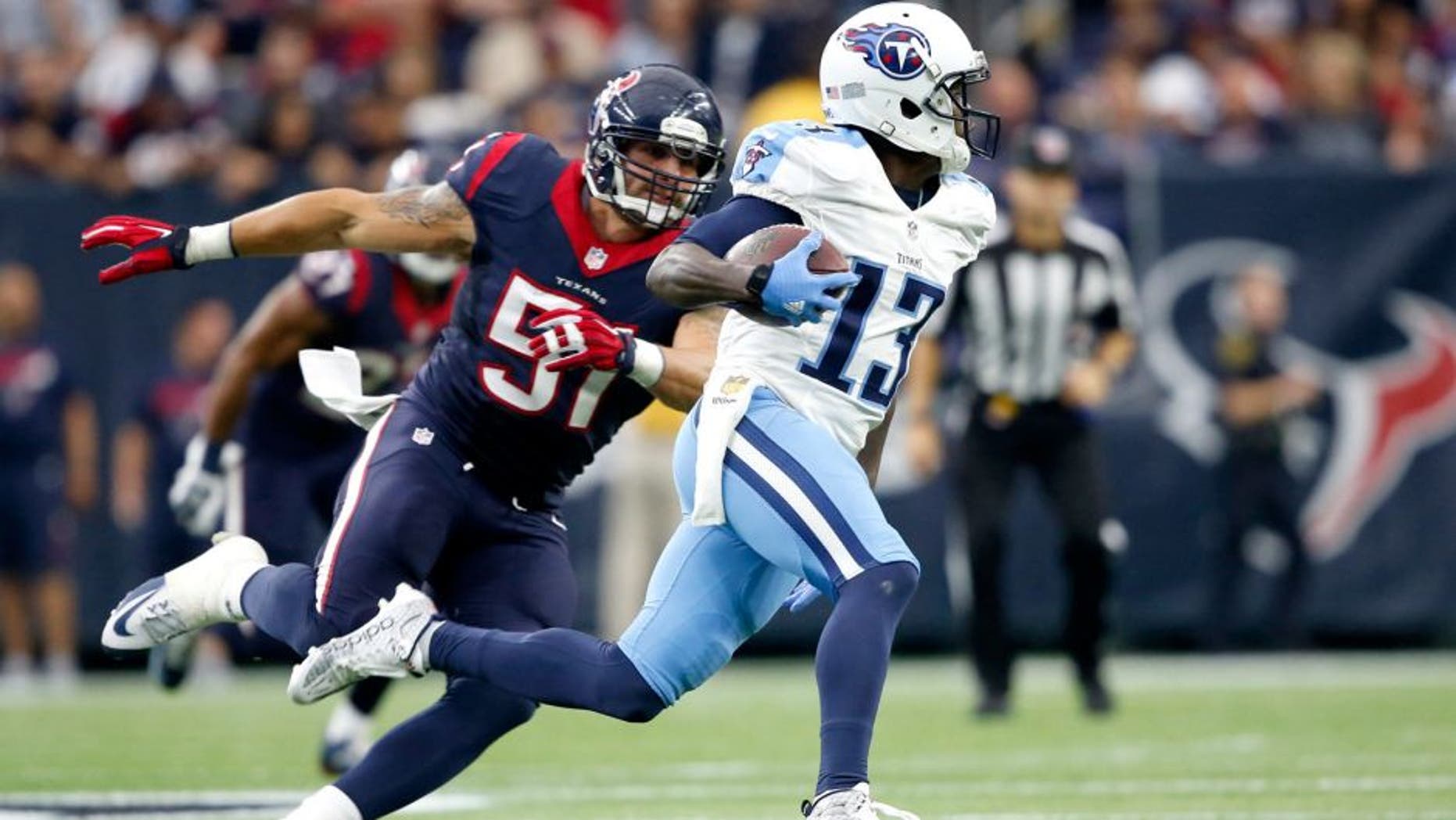 Nov 1, 2015; Houston, TX, USA; Tennessee Titans wide receiver Kendall Wright (13) avoids Houston Texans outside linebacker John Simon (51) in the second quarter at NRG Stadium. Mandatory Credit: Erich Schlegel-USA TODAY Sports