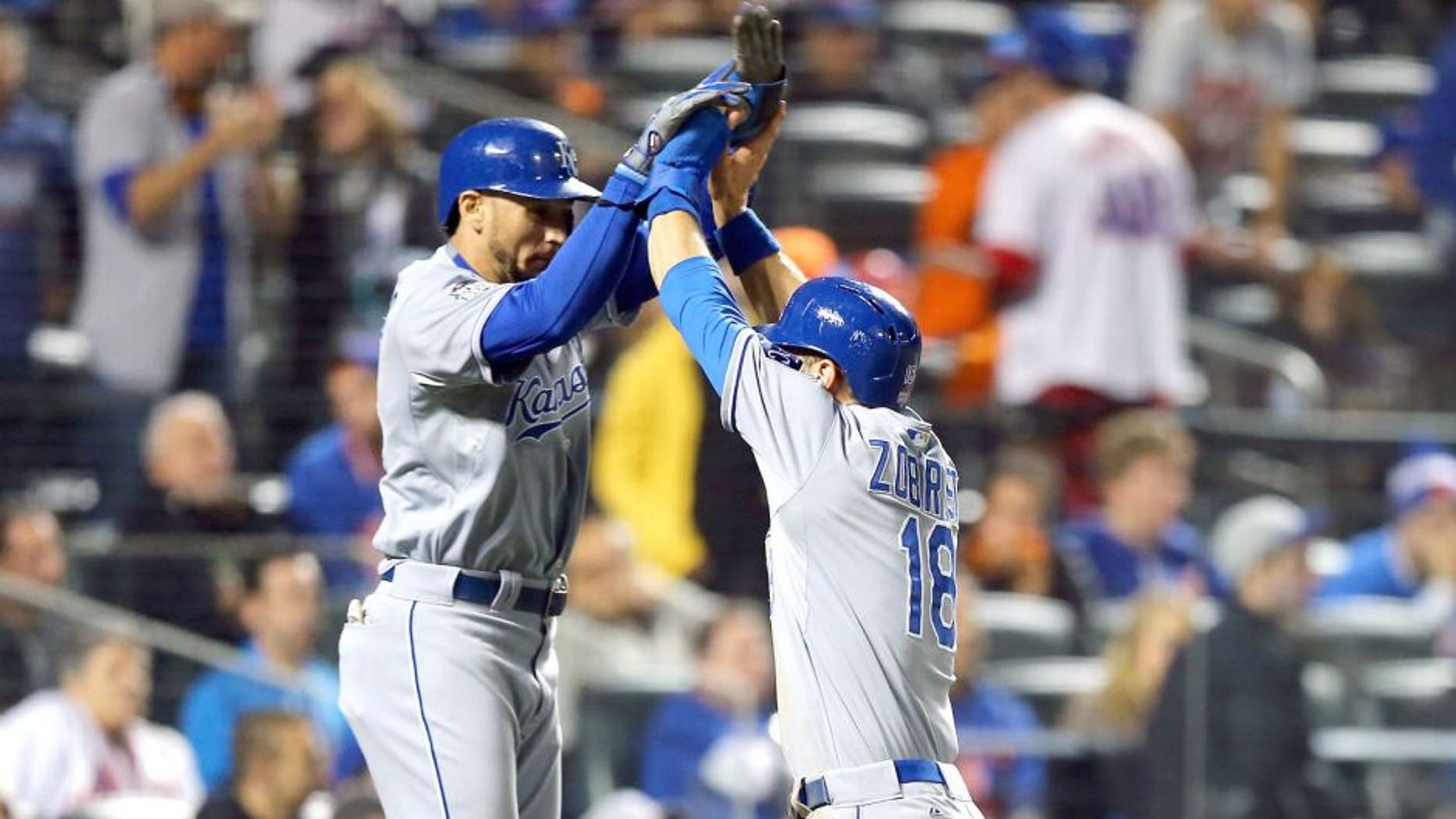 NEW YORK, NY - NOVEMBER 01: Ben Zobrist #18 of the Kansas City Royals celebrates with Christian Colon #16 and Alcides Escobar #2 after scoring off of a three run RBI double hit by Lorenzo Cain #6 in the twelfth inning against Bartolo Colon #40 of the New York Mets during Game Five of the 2015 World Series at Citi Field on November 1, 2015 in the Flushing neighborhood of the Queens borough of New York City. (Photo by Elsa/Getty Images)