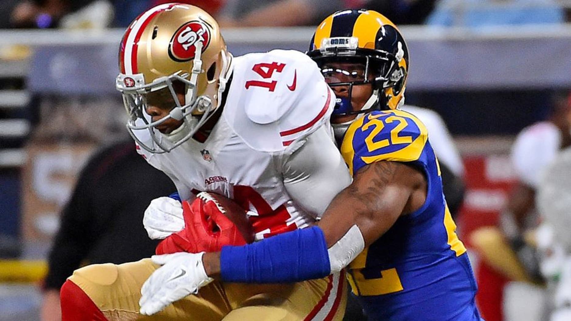 Nov 1, 2015; St. Louis, MO, USA; St. Louis Rams cornerback Trumaine Johnson (22) tackles San Francisco 49ers wide receiver Jerome Simpson (14) during the second half at the Edward Jones Dome. Mandatory Credit: Jasen Vinlove-USA TODAY Sports