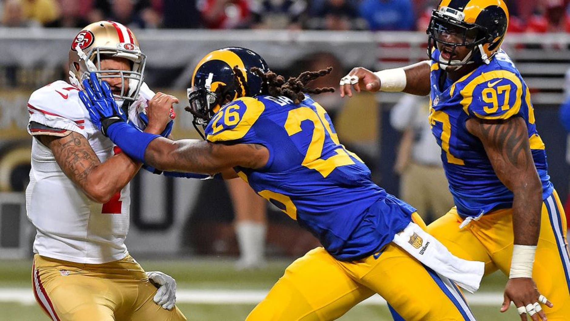 Nov 1, 2015; St. Louis, MO, USA; St. Louis Rams defensive tackle Aaron Donald (99) and Mark Barron (26) tackle San Francisco 49ers quarterback Colin Kaepernick (7) during the second half at the Edward Jones Dome. Mandatory Credit: Jasen Vinlove-USA TODAY Sports