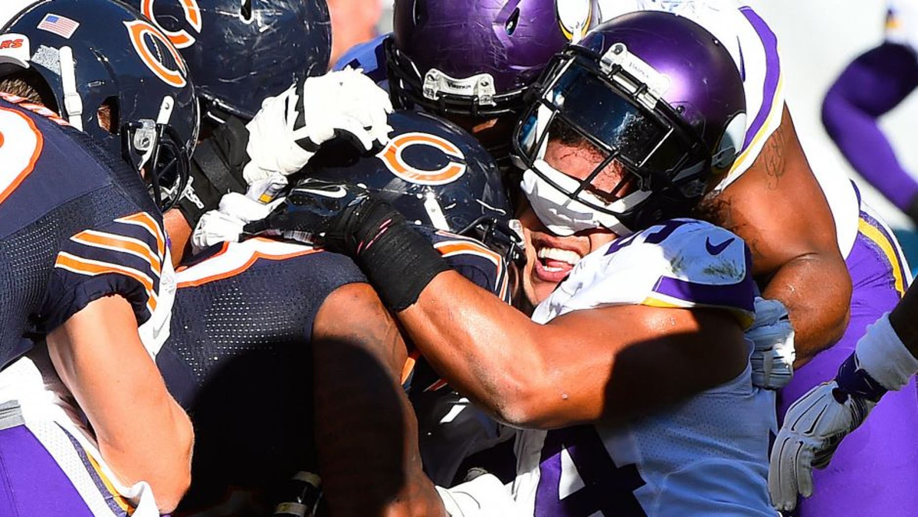 Nov 1, 2015; Chicago, IL, USA; Minnesota Vikings middle linebacker Eric Kendricks (54) has his helmet knocked off by Chicago Bears running back Jeremy Langford (33) during the second half at Soldier Field. Mandatory Credit: Mike DiNovo-USA TODAY Sports