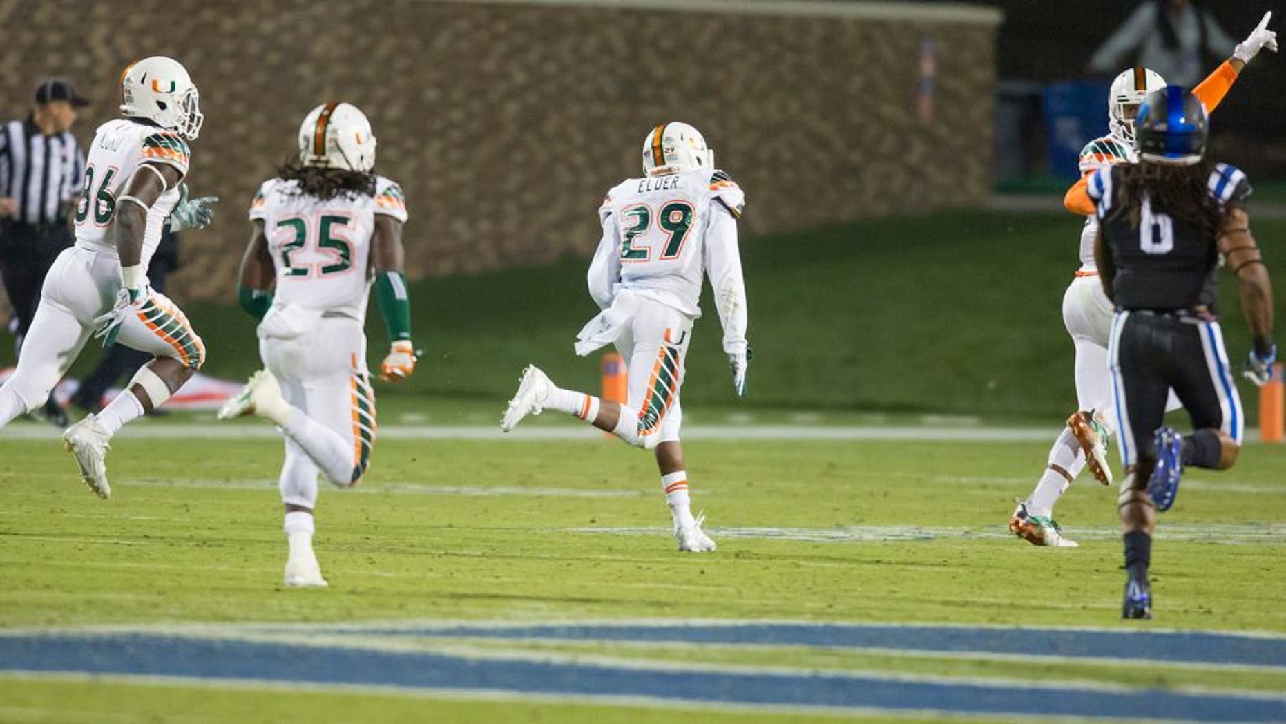 Miami's Corn Elder (29) returns a kickoff, which featured multiple laterals before Elder subsequently received the final lateral, and scores to beat Duke 30-27 in an NCAA college football game, in Durham, N.C., Saturday, Oct. 31, 2015. (AP Photo/Rob Brown)