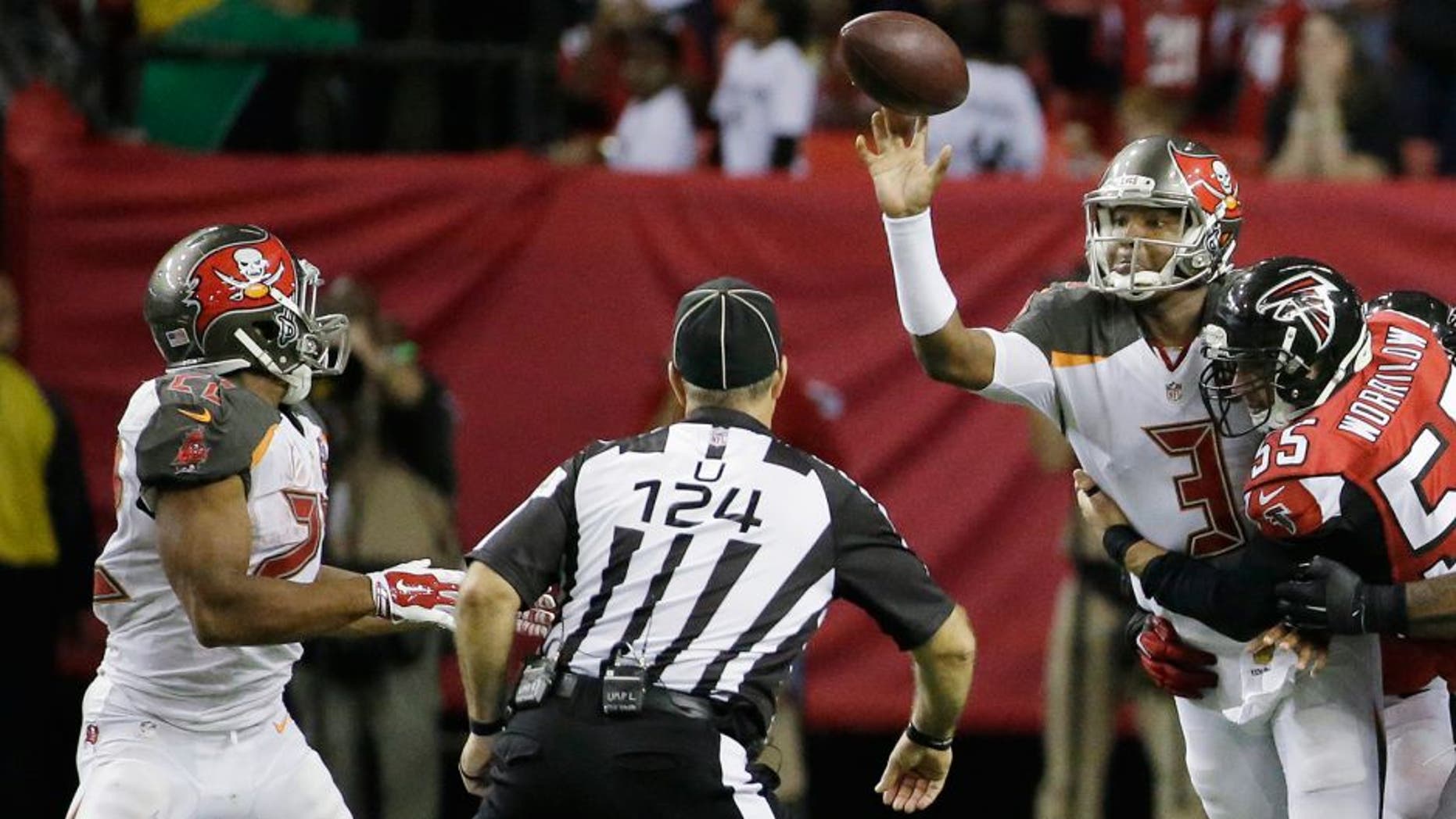 Tampa Bay Buccaneers quarterback Jameis Winston (3) makes the pass to Tampa Bay Buccaneers running back Doug Martin (22) as Atlanta Falcons middle linebacker Paul Worrilow (55) is hitting during the second of an NFL football game, Sunday, Nov. 1, 2015, in Atlanta. (AP Photo/David Goldman)