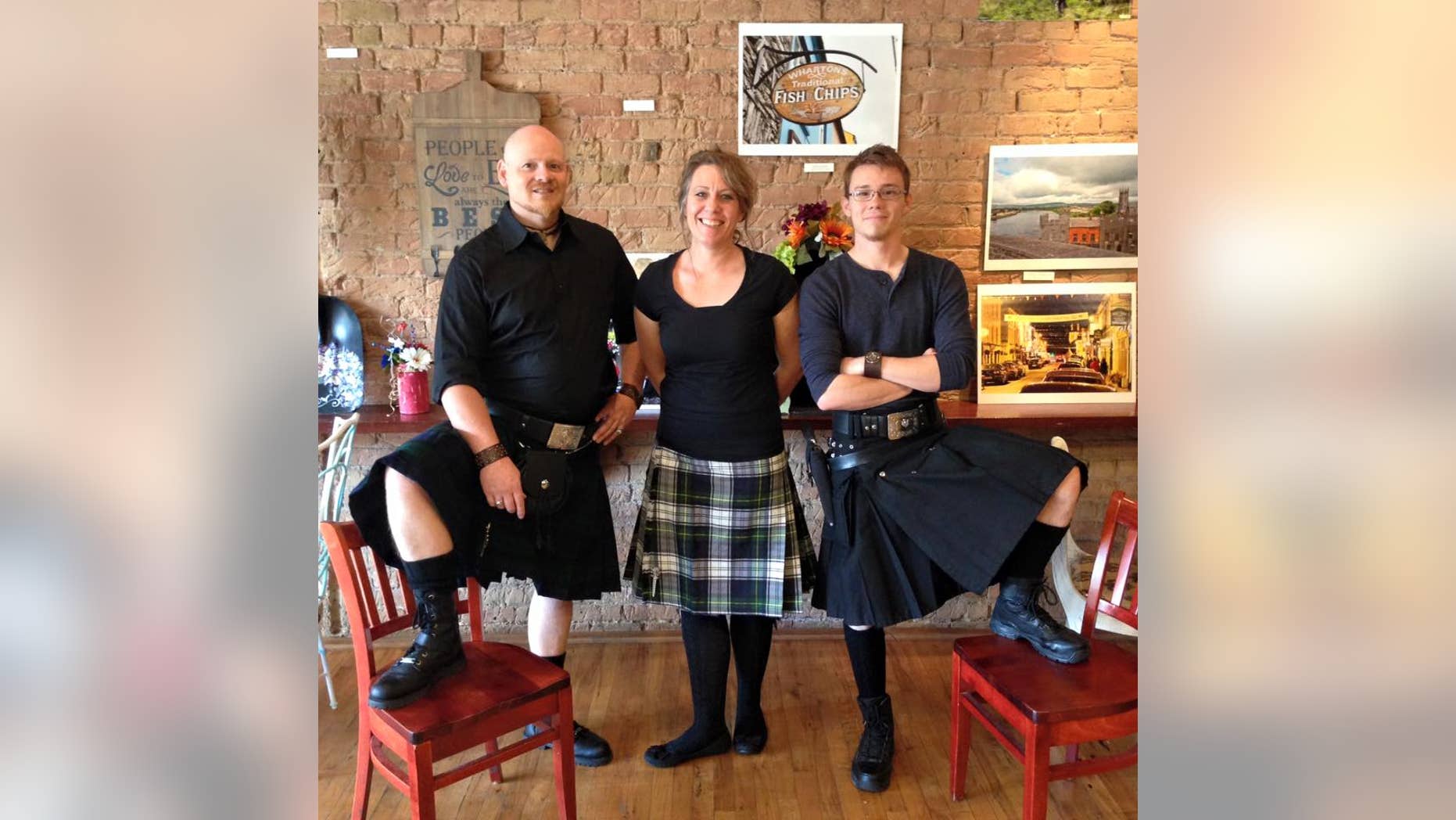 Tony Siebers, left, Monika Siebers and son Collin Siebers wear kilts and carry guns at Sea Bears Ogden Fish House in Utah.