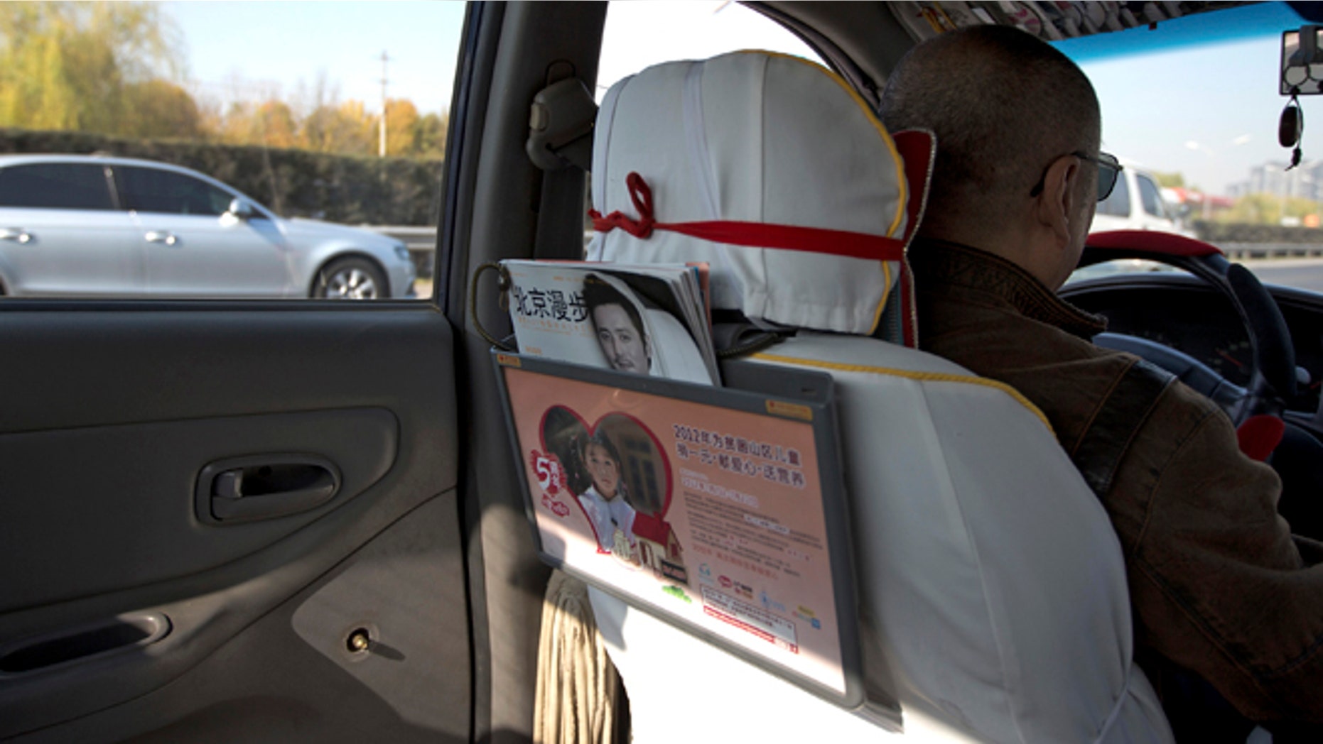Nov. 1, 2012: A window handle on the door at the back seat is seen removed in a taxi in Beijing. Not only have taxi drivers removed the window handles from their doors, but their passengers must sign agreements promising to keep their windows and doors locked.