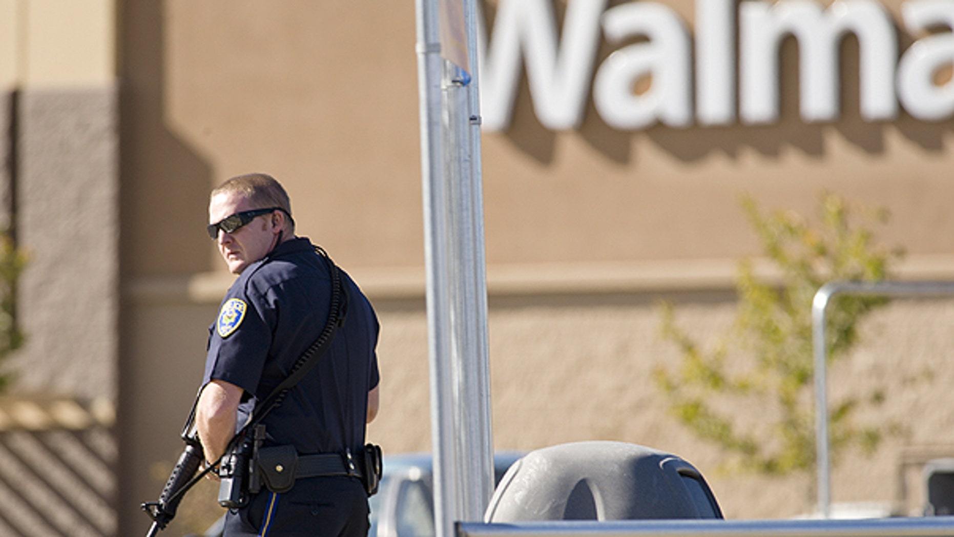 Oct. 29: Reno police officers search through trash cans in the parking lot during a standoff following a shooting at a Reno Walmart.