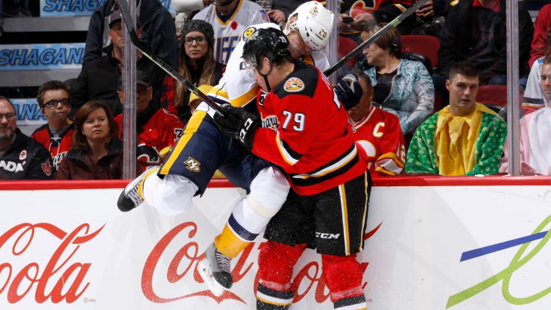 CALGARY, AB - OCTOBER 31: Michael Ferland #79 of the Calgary Flames checks Anton Volchenkov #20 of the Nashville Predators into the boards at Scotiabank Saddledome on October 31, 2014 in Calgary, Alberta, Canada. (Photo by Gerry Thomas/NHLI via Getty Images)