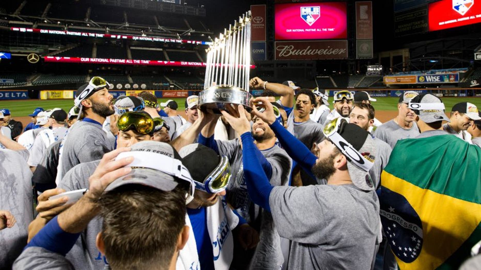 NEW YORK, NY - NOVEMBER 1: Members of the Kansas City Royals hoist up the Commissioner's Trophy on the field after defeating the New York Mets in Game 5 of the 2015 World Series at Citi Field on Sunday, November 1, 2015 in the Queens borough of New York City. (Photo by Rob Tringali/MLB Photos via Getty Images)