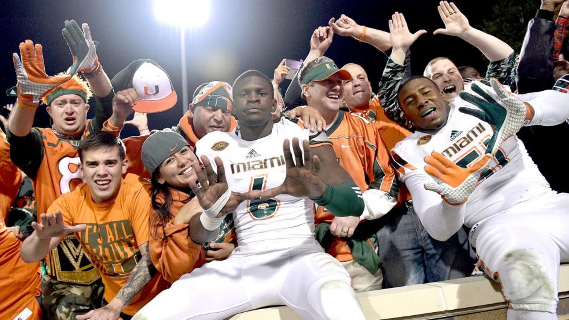 DURHAM, NC - OCTOBER 31: Miami Hurricanes players and fans celebrate after a win against the Duke Blue Devils at Wallace Wade Stadium on October 31, 2015 in Durham, North Carolina. Miami won 30-27 on a last-second touchdown. (Photo by Grant Halverson/Getty Images)
