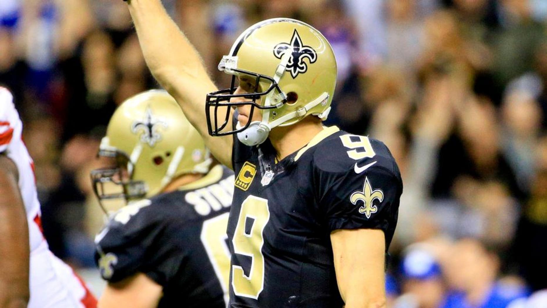Nov 1, 2015; New Orleans, LA, USA; New Orleans Saints quarterback Drew Brees (9) reacts after throwing his seventh touchdown pass of the game during the fourth quarter against the New York Giants at the Mercedes-Benz Superdome. The Saints defeated the Giants 52-49. Mandatory Credit: Derick E. Hingle-USA TODAY Sports
