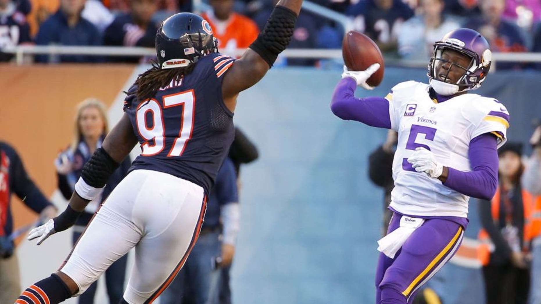 Nov 1, 2015; Chicago, IL, USA; Minnesota Vikings quarterback Teddy Bridgewater (5) throws the ball over Chicago Bears outside linebacker Willie Young (97) during the fourth quarter at Soldier Field. The Vikings won 23-20. Mandatory Credit: Kamil Krzaczynski-USA TODAY Sports
