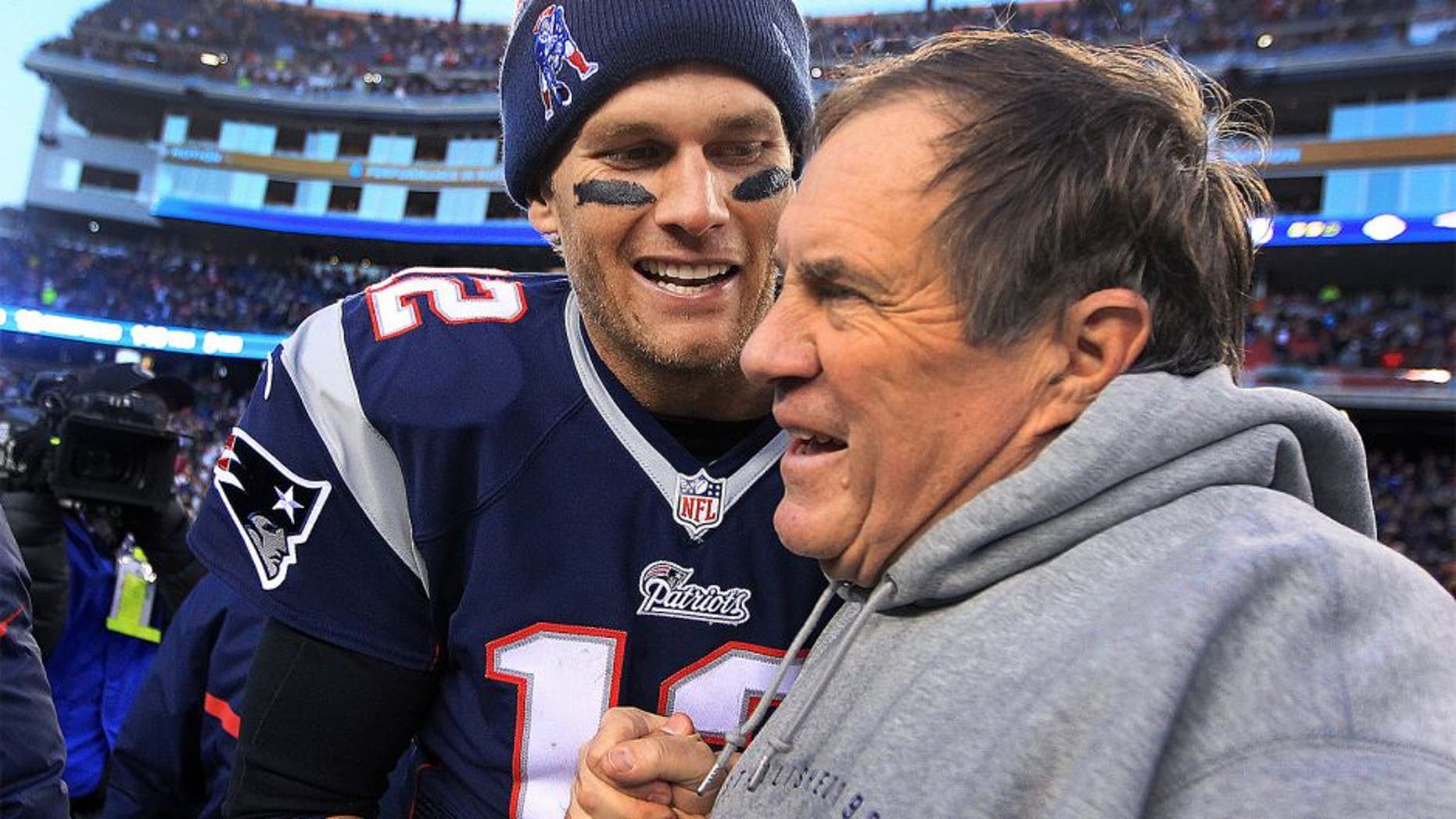 FOXBOROUGH, MA - DECEMBER 14: Patriots quarterback Tom Brady and head coach Bill Belichick share a moment as the final seconds tick off the clock in their victory, which gave them their 6th straight AFC East title. The New England Patriots hosted the Miami Dolphins in a regular season NFL game at Gillette Stadium. (Photo by Jim Davis/The Boston Globe via Getty Images)