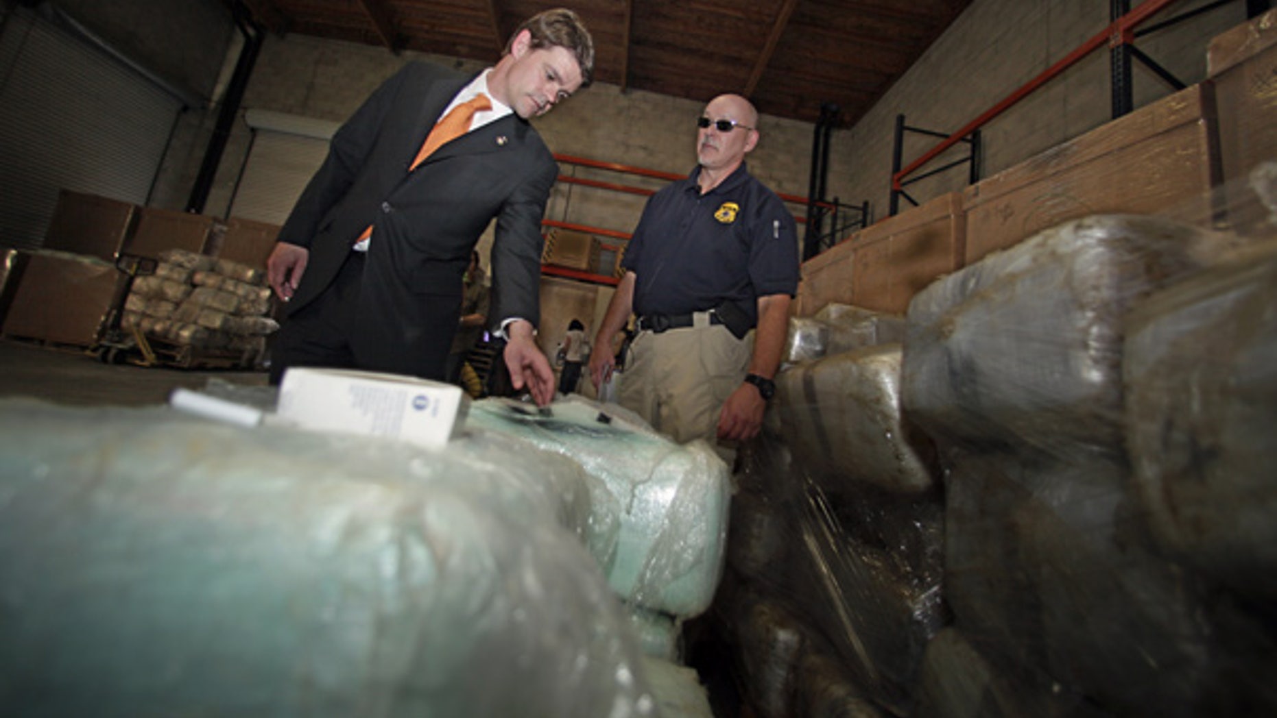 Nov. 3: Director of Immigration and Customs Enforcement John Morton, left, inspects a bundle of marijuana with a Homeland Security agent at a warehouse near the U.S.-Mexico border.