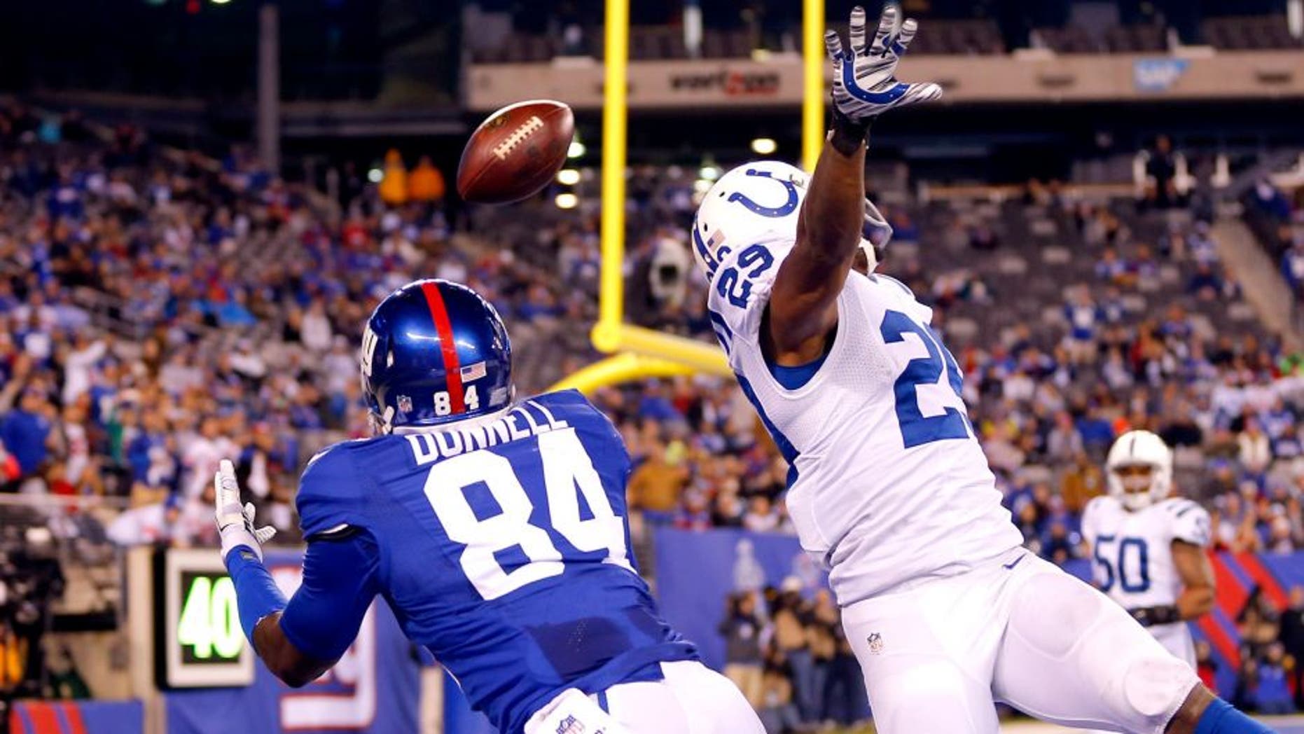 Nov 3, 2014; East Rutherford, NJ, USA; New York Giants tight end Larry Donnell (84) dives for touchdown pass over out stretched hands of Indianapolis Colts strong safety Mike Adams (29) during the second half at MetLife Stadium. Indianapolis Colts defeat the New York Giants 40-24. Mandatory Credit: Jim O'Connor-USA TODAY Sports