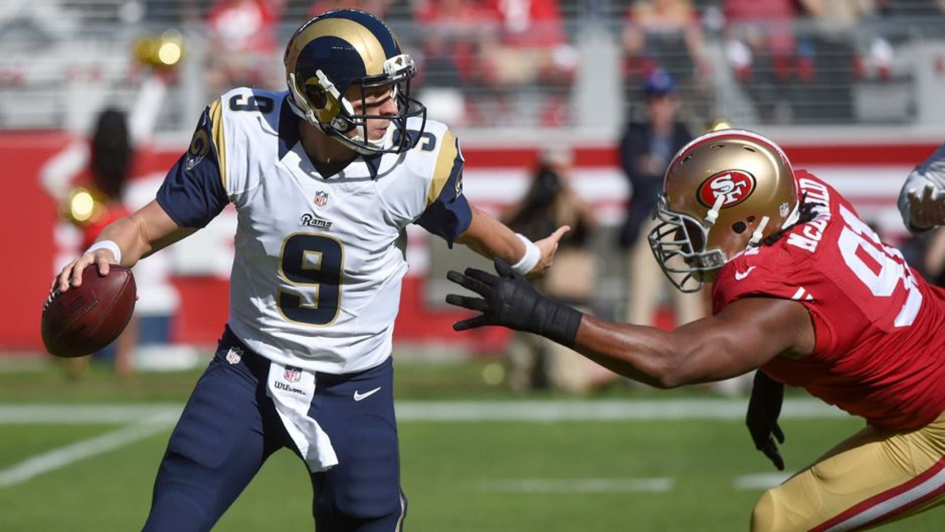 November 2, 2014; Santa Clara, CA, USA; St. Louis Rams quarterback Austin Davis (9) scrambles from San Francisco 49ers defensive end Ray McDonald (91) during the first quarter at Levi's Stadium. Mandatory Credit: Kyle Terada-USA TODAY Sports