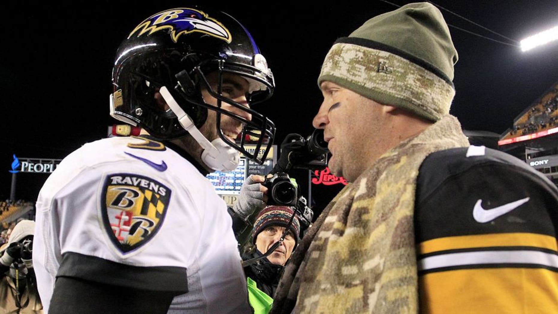 Nov 2, 2014; Pittsburgh, PA, USA; Baltimore Ravens quarterback Joe Flacco (left) and Pittsburgh Steelers quarterback Ben Roethlisberger (right) meet at mid-field after their game at Heinz Field. The Steelers won 43-23. Mandatory Credit: Charles LeClaire-USA TODAY Sports