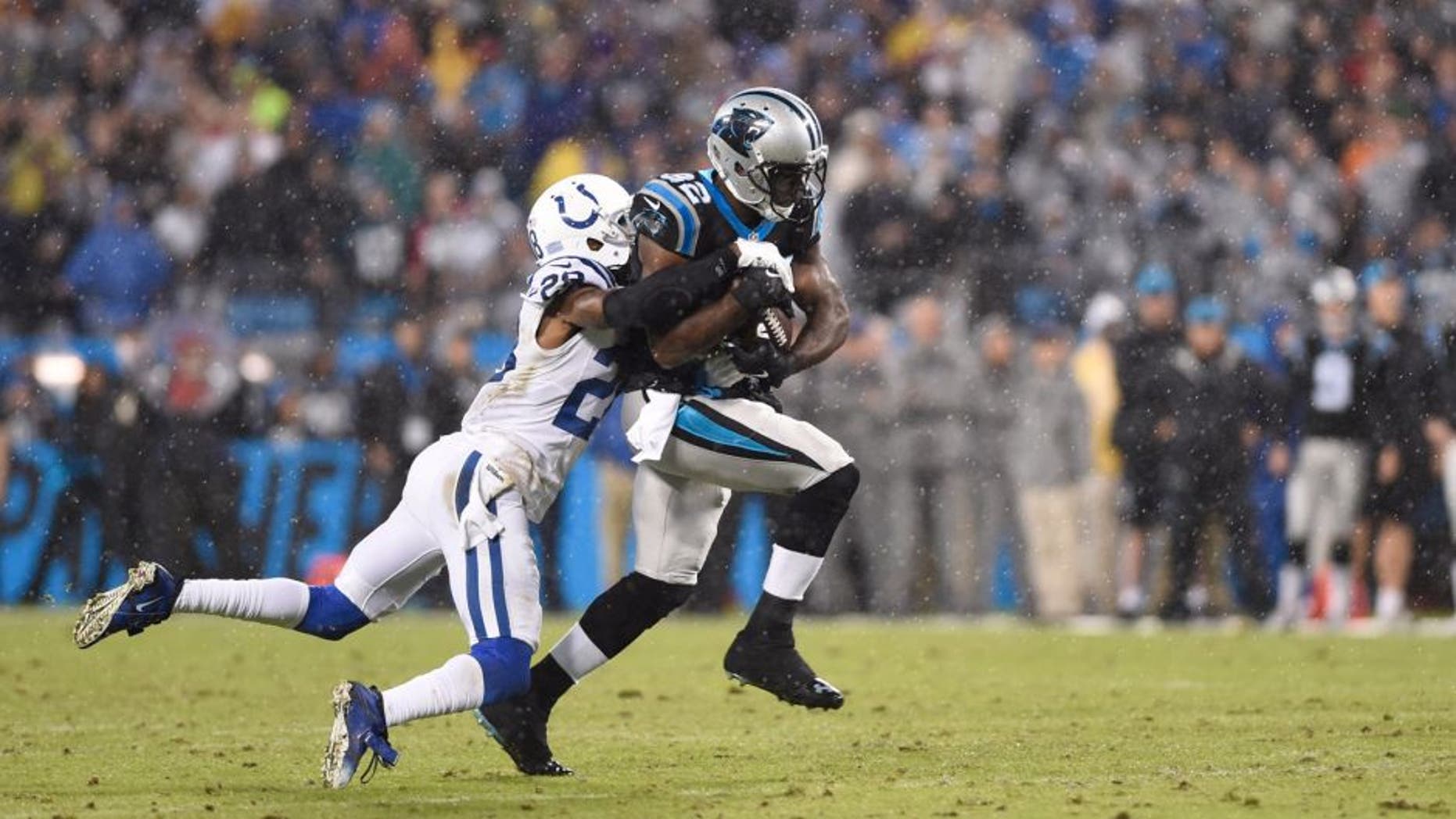 Nov 2, 2015; Charlotte, NC, USA; Carolina Panthers running back Jonathan Stewart (28) runs as Indianapolis Colts cornerback Greg Toler (28) defends in the first quarter at Bank of America Stadium. Mandatory Credit: Bob Donnan-USA TODAY Sports