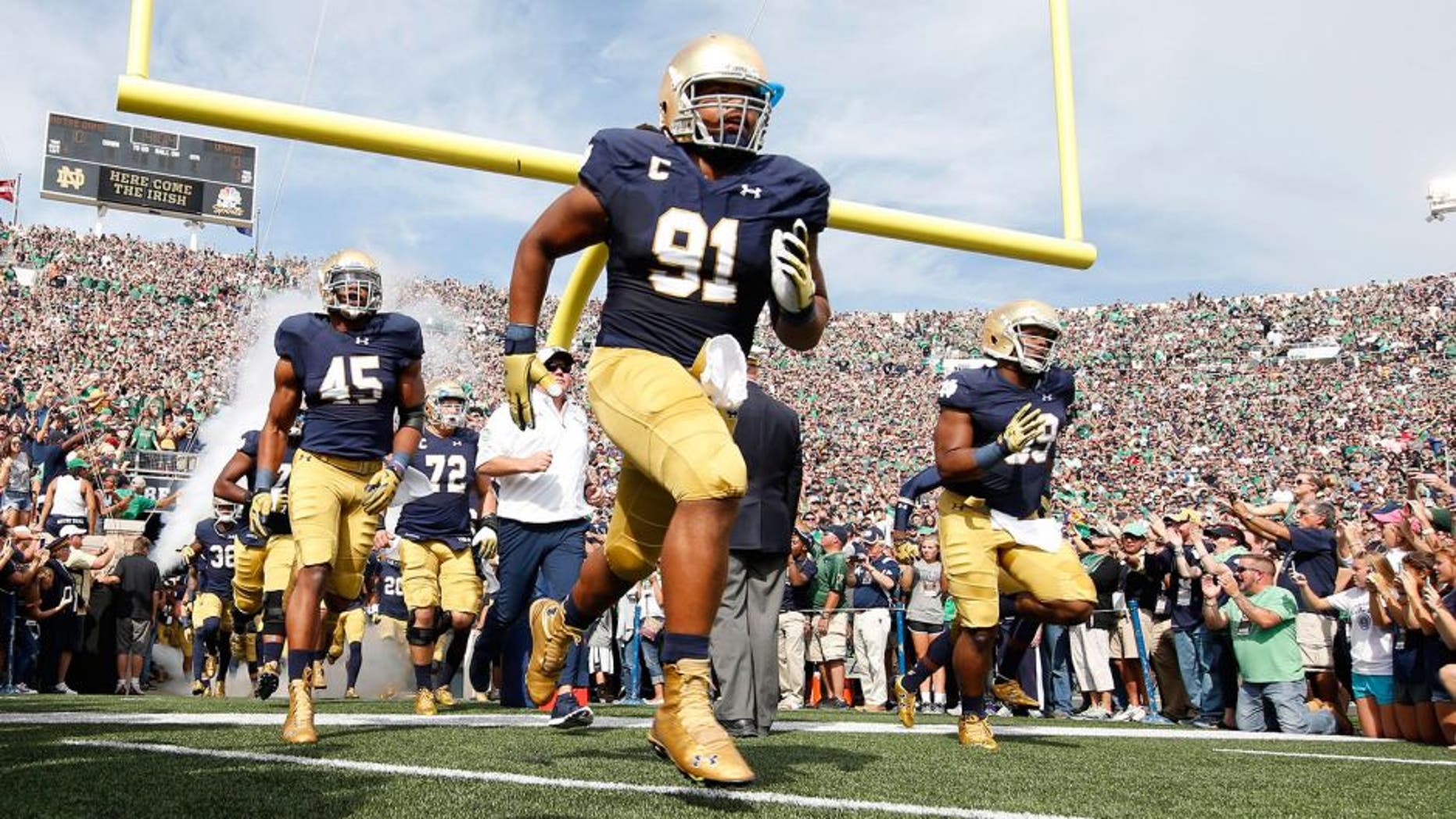Sep 26, 2015; South Bend, IN, USA; Notre Dame Fighting Irish defensive lineman Sheldon Day (91) leads the team onto the field before the game against the Massachusetts Minutemen at Notre Dame Stadium. Mandatory Credit: Brian Spurlock-USA TODAY Sports