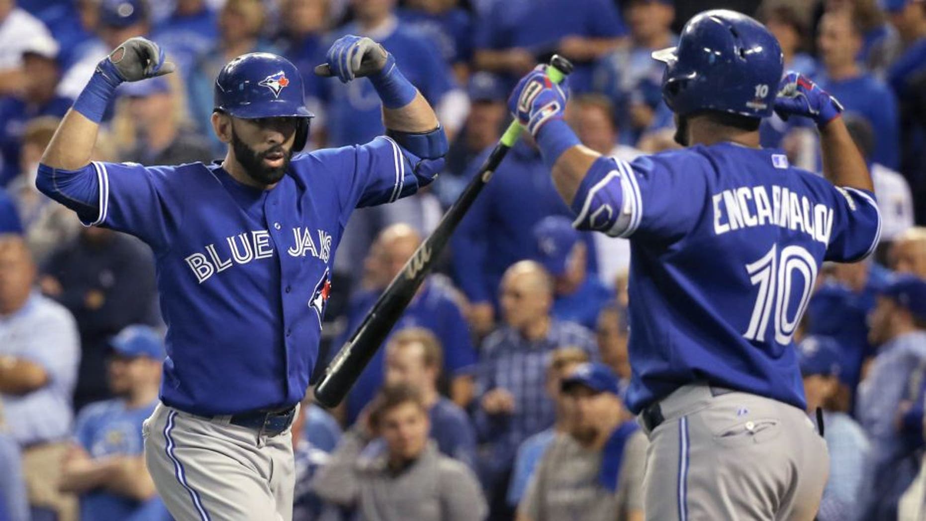 KANSAS CITY, MO - OCTOBER 23: Toronto Blue Jays right fielder Jose Bautista (19) and Toronto Blue Jays designated hitter Edwin Encarnacion (10) celebrate Bautista's 2 run home run in the top of the 8th inning to tie the game. Toronto Blue Jays Vs Kansas City Royals in Game 6 of the ALCS at Kauffman Field. Jays lose 4-3 and lose the series 4-2. Kansas City goes on to the World Series against the New York Mets. Toronto Star/Rick Madonik (Rick Madonik/Toronto Star via Getty Images)