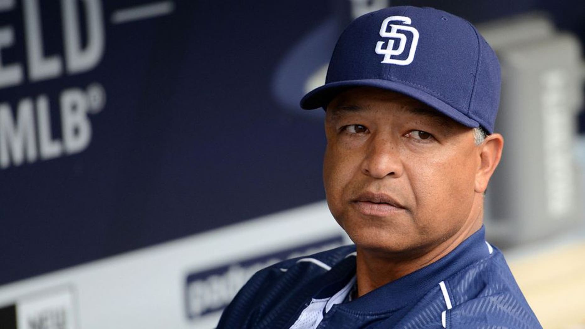 Jun 15, 2015; San Diego, CA, USA; San Diego Padres interim manager Dave Roberts (8) looks on from the dugout prior to the game against the Oakland Athletics at Petco Park. Mandatory Credit: Jake Roth-USA TODAY Sports