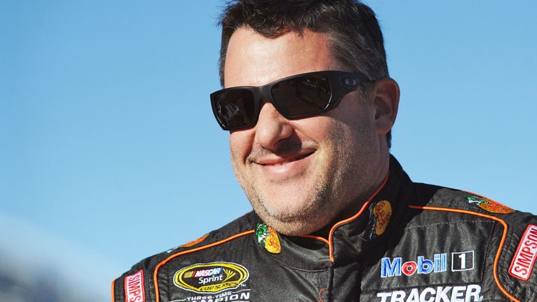 MARTINSVILLE, VA - OCTOBER 30: Tony Stewart, driver of the #14 Bass Pro Shops/Mobil 1 Chevrolet, stands on the grid during qualifying for the NASCAR Sprint Cup Series Goody's Headache Relief Shot 500 at Martinsville Speedway on October 30, 2015 in Martinsville, Virginia. (Photo by Rainier Ehrhardt/Getty Images)