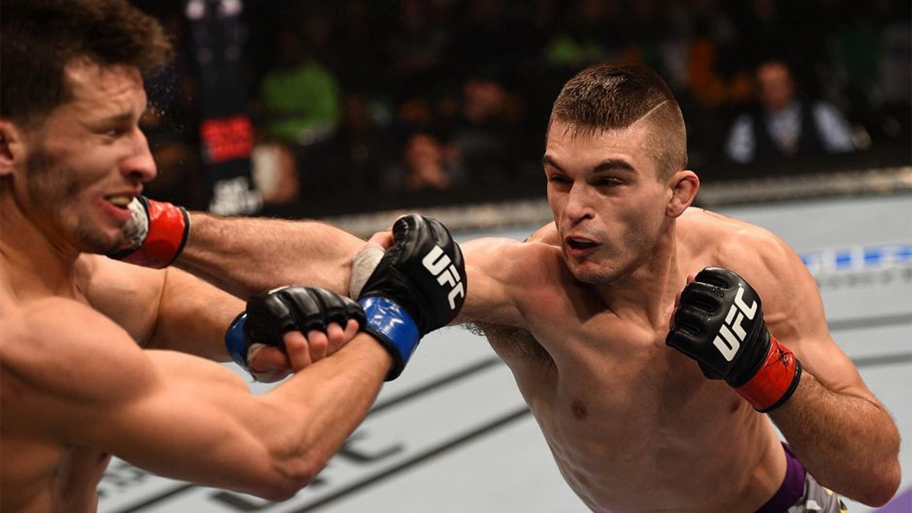 BOSTON, MA - JANUARY 18: (R-L) Johnny Case punches Frankie Perez in their lightweight fight during the UFC Fight Night event at the TD Garden on January 18, 2015 in Boston, Massachusetts. (Photo by Jeff Bottari/Zuffa LLC/Zuffa LLC via Getty Images)