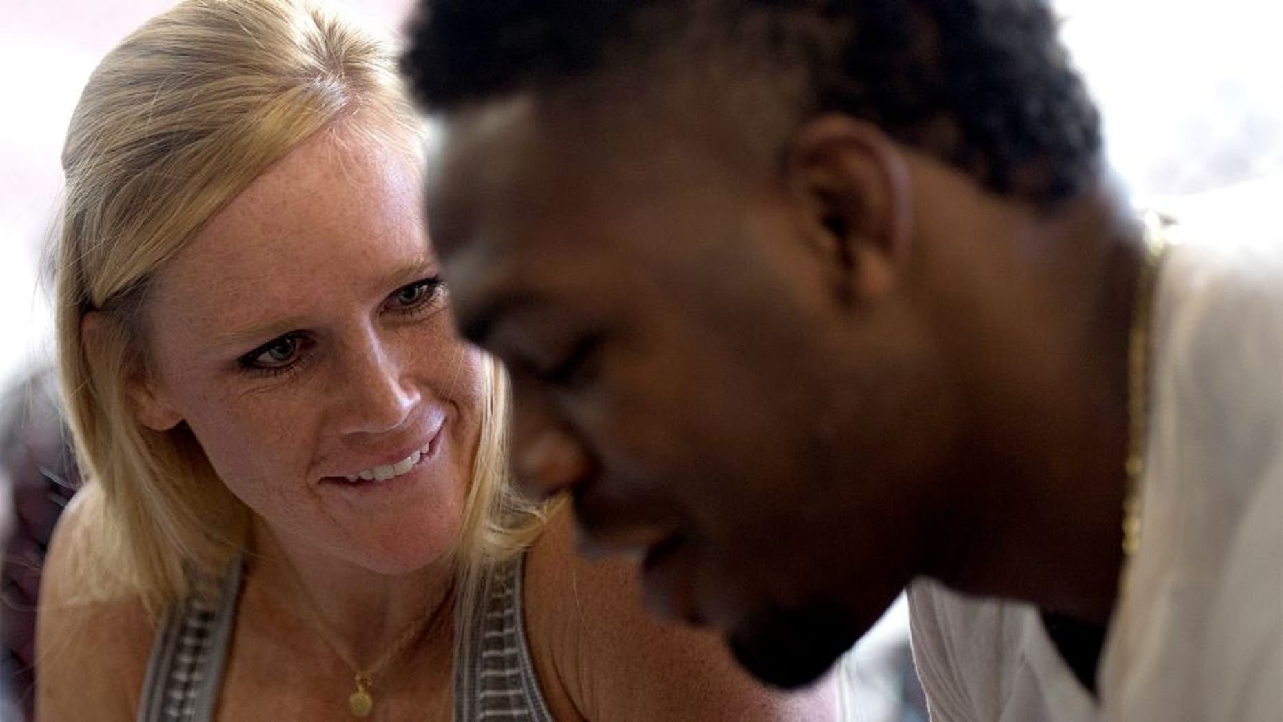 ALBUQUERQUE, NM - OCTOBER 31: (L-R) Holly Holm and Jon Jones sign autographs for fans during the Jackson Wink MMA Academy Grand Opening at Jackson's Mixed Martial Arts & Fitness on October 31, 2015 in Albuquerque, New Mexico. (Photo by Brandon Magnus/Zuffa LLC/Zuffa LLC via Getty Images)
