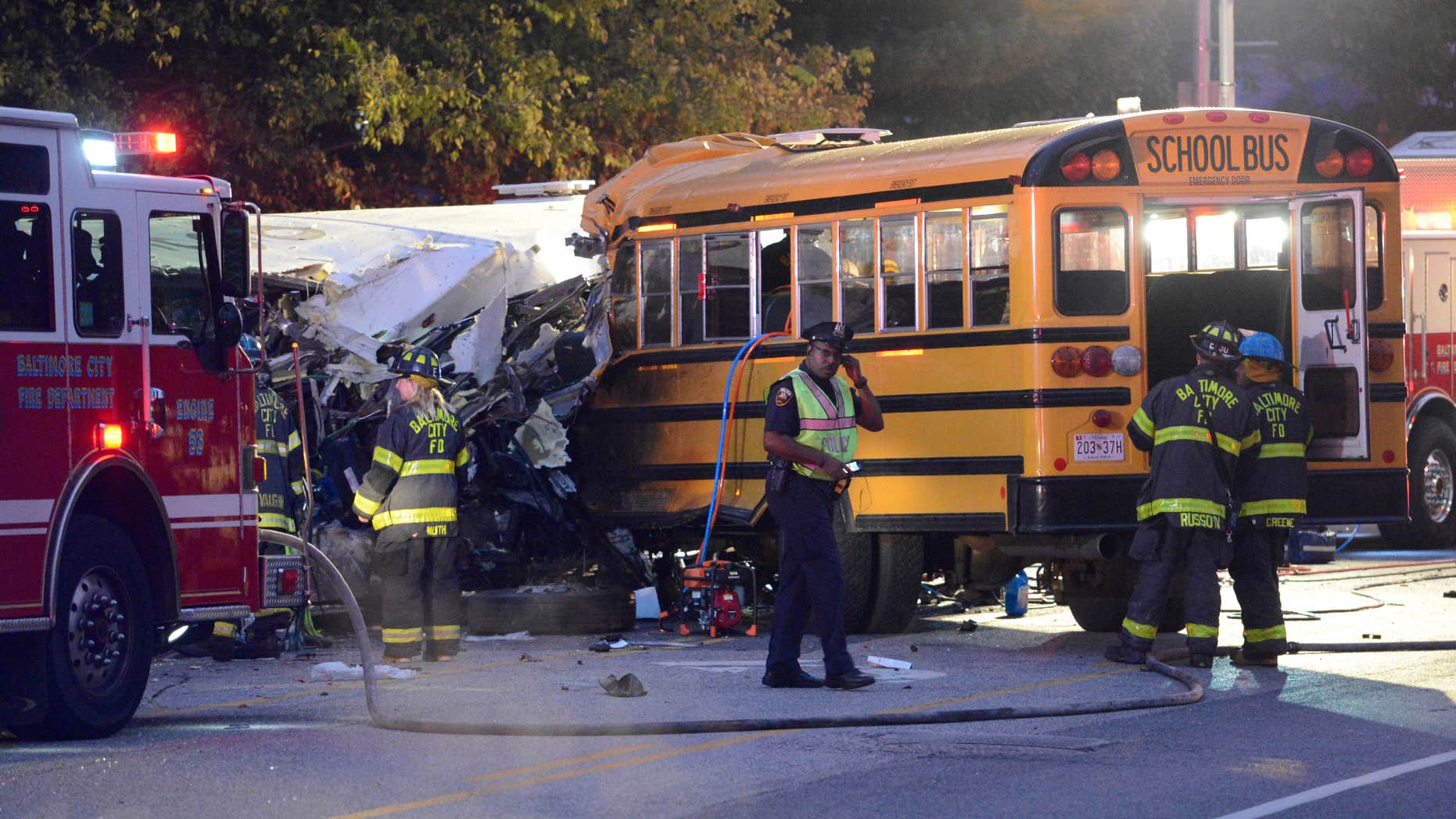 Fire department and rescue officials are at the scene of an early morning fatal collision between a school bus and a commuter bus Tuesday, Nov. 1, 2016, in Baltimore.