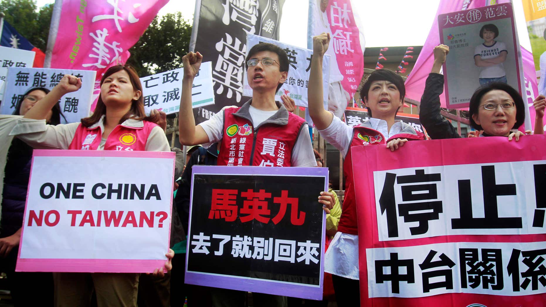 Nov. 4, 2015: Opposition protesters shout slogans with placards opposing the planned meeting of Taiwan's President Ma Ying-jeou with his China counterpart Xi Jinping in Taipei, Taiwan.