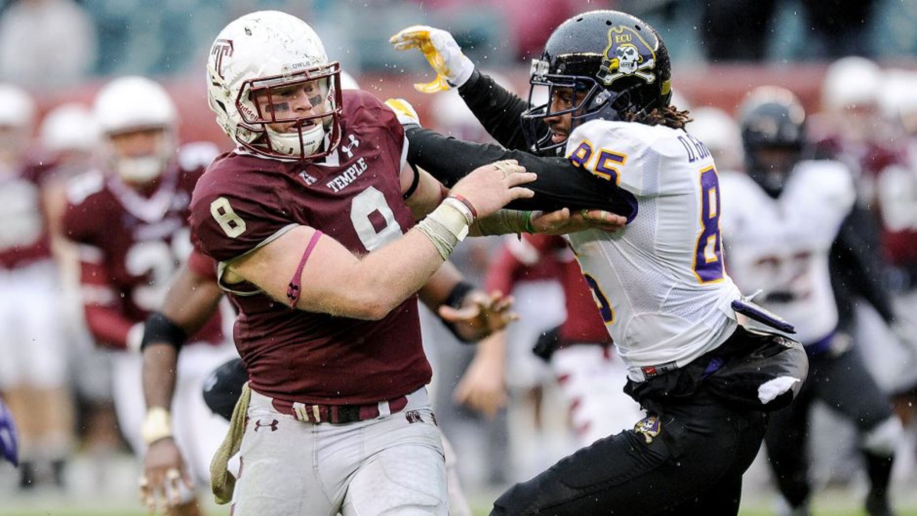 Nov 1, 2014; Philadelphia, PA, USA; Temple Owls linebacker Tyler Matakevich (8) gets past East Carolina Pirates wide receiver Davon Grayson (85) during the fourth quarter at Lincoln Financial Field. The Owls won the game 20-10. Mandatory Credit: John Geliebter-USA TODAY Sports