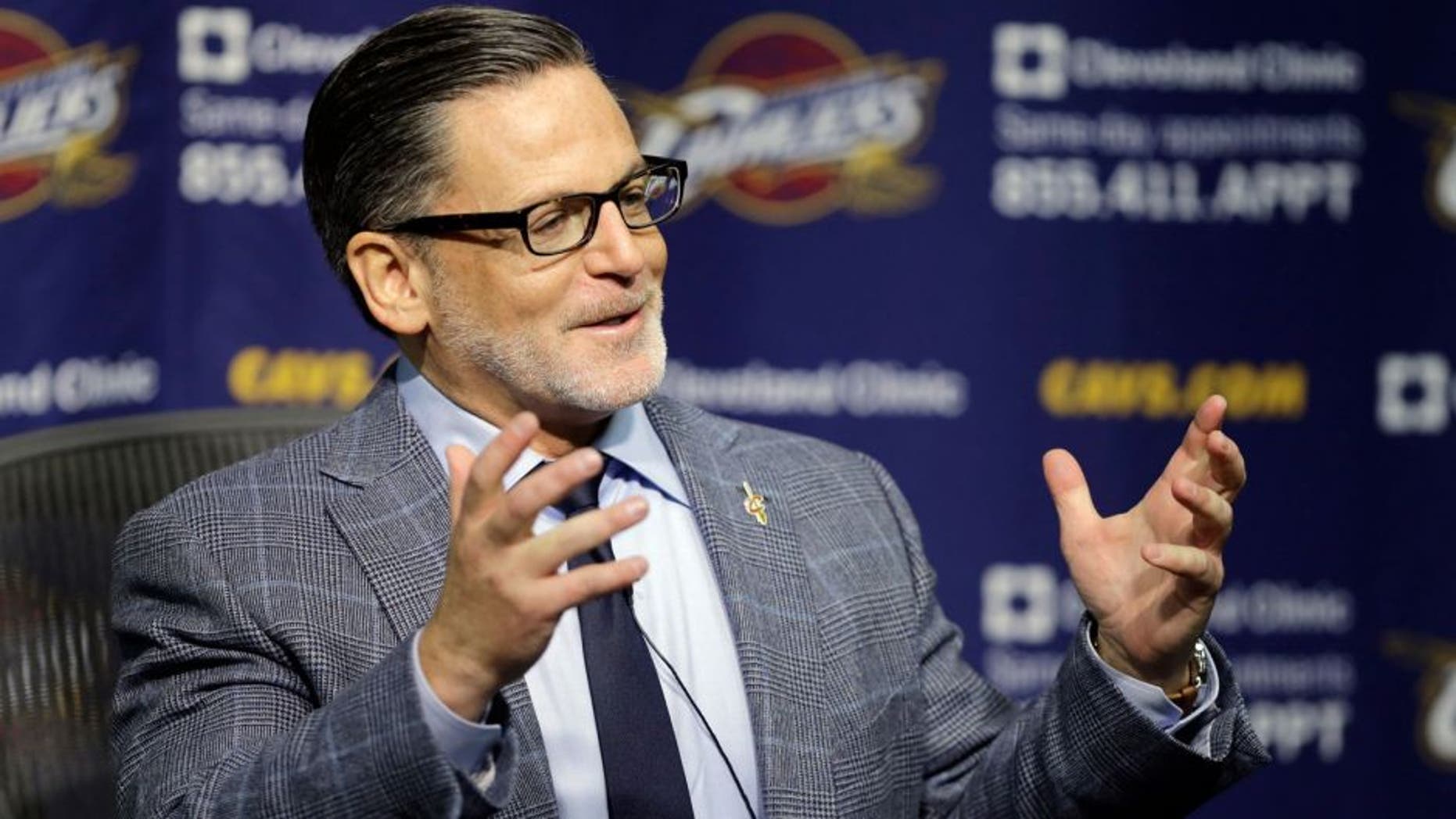 Cleveland Cavaliers owner Dan Gilbert answers questions during a news conference on the day before the NBA basketball team's opening game Wednesday, Oct. 29, 2014, in Cleveland. (AP Photo/Mark Duncan)