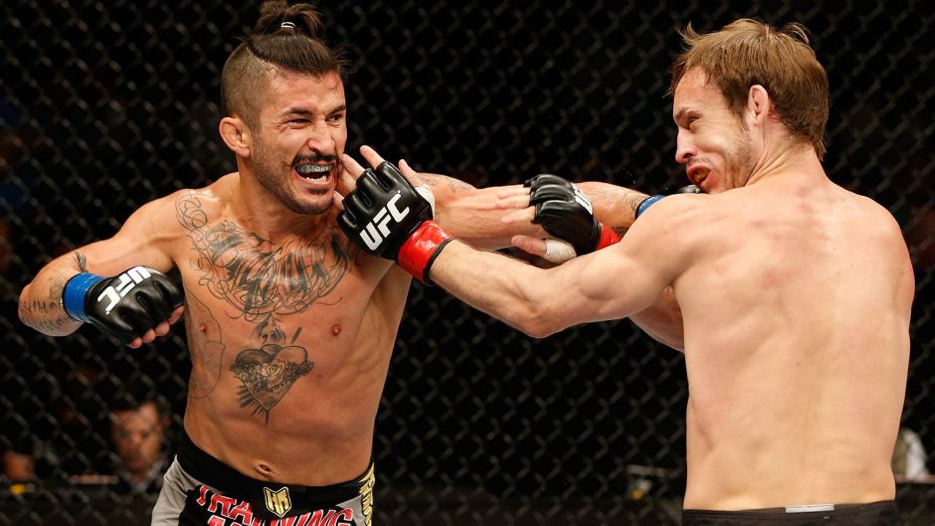 DUBLIN, IRELAND - JULY 19: (L-R) Ian McCall connects with a left against Brad Pickett in their flyweight bout during the UFC Fight Night event at The O2 Dublin on July 19, 2014 in Dublin, Ireland. (Photo by Josh Hedges/Zuffa LLC/Zuffa LLC via Getty Images)