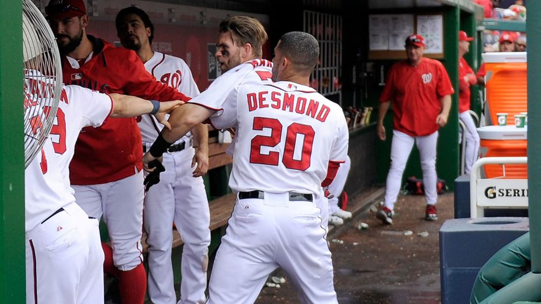 WASHINGTON, DC - SEPTEMBER 27: Bryce Harper #34 of the Washington Nationals is pulled away by Ian Desmond #20 after an altercation with Jonathan Papelbon #58 (not pictured) in the eighth inning against the Philadelphia Phillies at Nationals Park on September 27, 2015 in Washington, DC. (Photo by Greg Fiume/Getty Images)