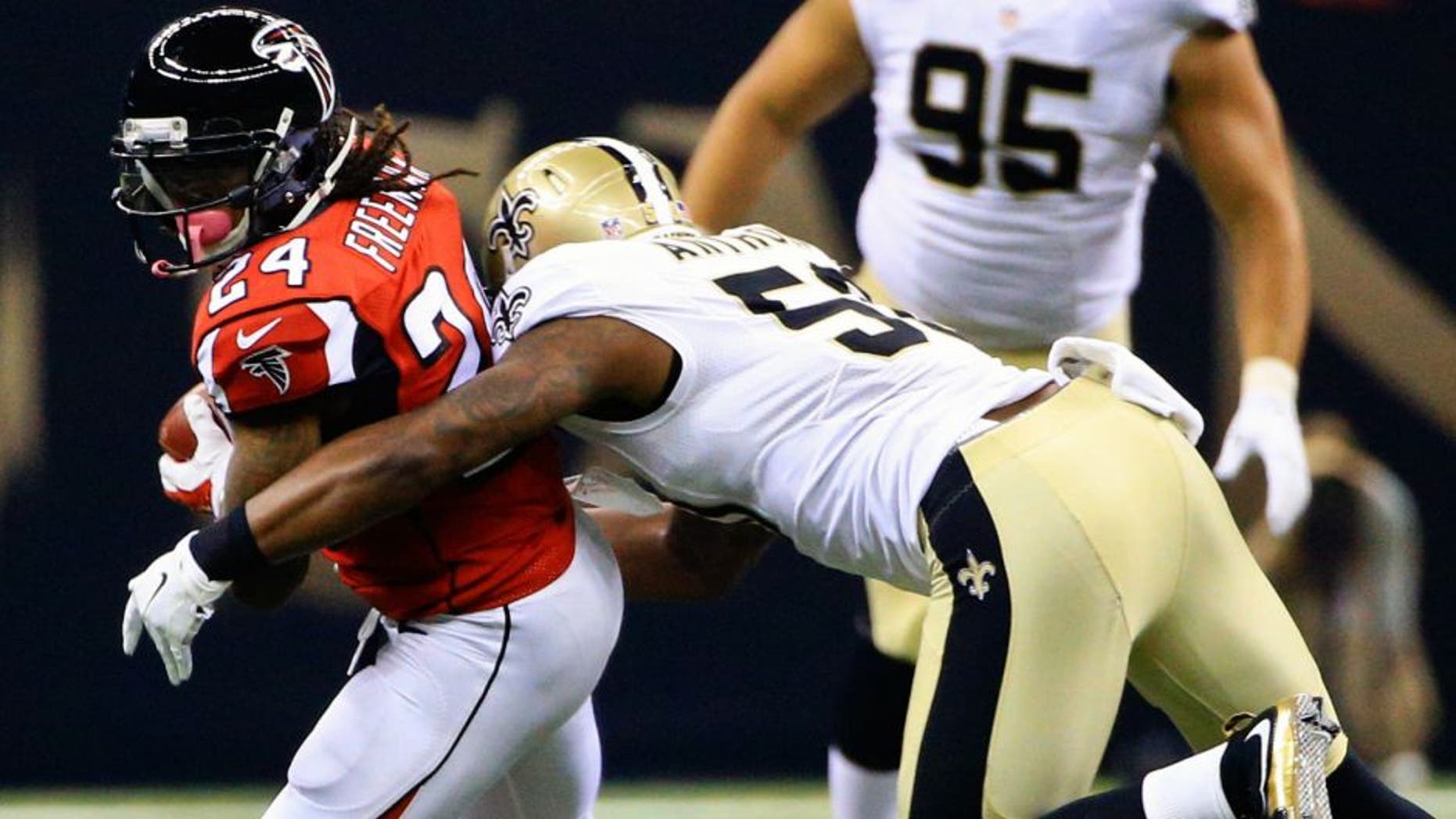 Oct 15, 2015; New Orleans, LA, USA; Atlanta Falcons running back Devonta Freeman (24) is tackled by New Orleans Saints middle linebacker Stephone Anthony (50) during the first quarter of a game at the Mercedes-Benz Superdome. Mandatory Credit: Derick E. Hingle-USA TODAY Sports