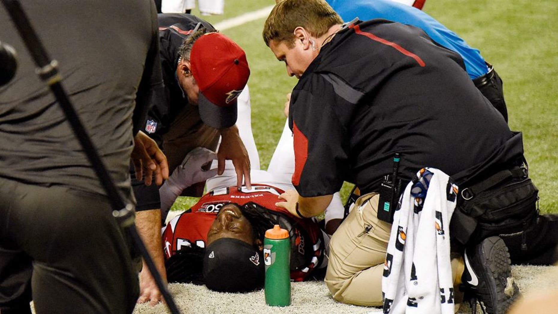 Nov 1, 2015; Atlanta, GA, USA; Atlanta Falcons cornerback Desmond Trufant (21) is attended by team personnel after being injured against the Tampa Bay Buccaneers during the second half at the Georgia Dome. The Buccaneers defeated the Falcons 23-20 in over time. Mandatory Credit: Dale Zanine-USA TODAY Sports