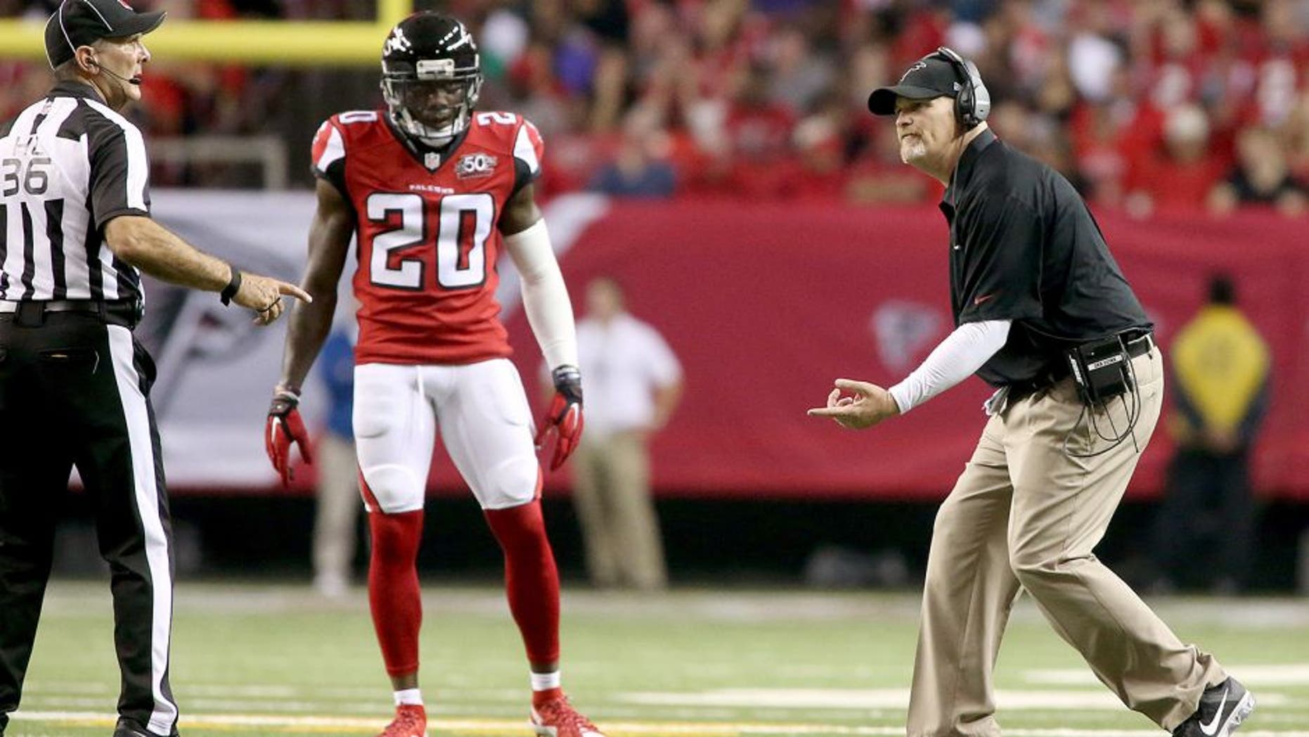 Nov 1, 2015; Atlanta, GA, USA; Atlanta Falcons head coach Dan Quinn argues a call with official Tony Veteri (36) as defensive back Phillip Adams (20) watches in the fourth quarter of their game against the Tampa Bay Buccaneers at the Georgia Dome. The Buccaneers won 23-20 in overtime. Mandatory Credit: Jason Getz-USA TODAY Sports