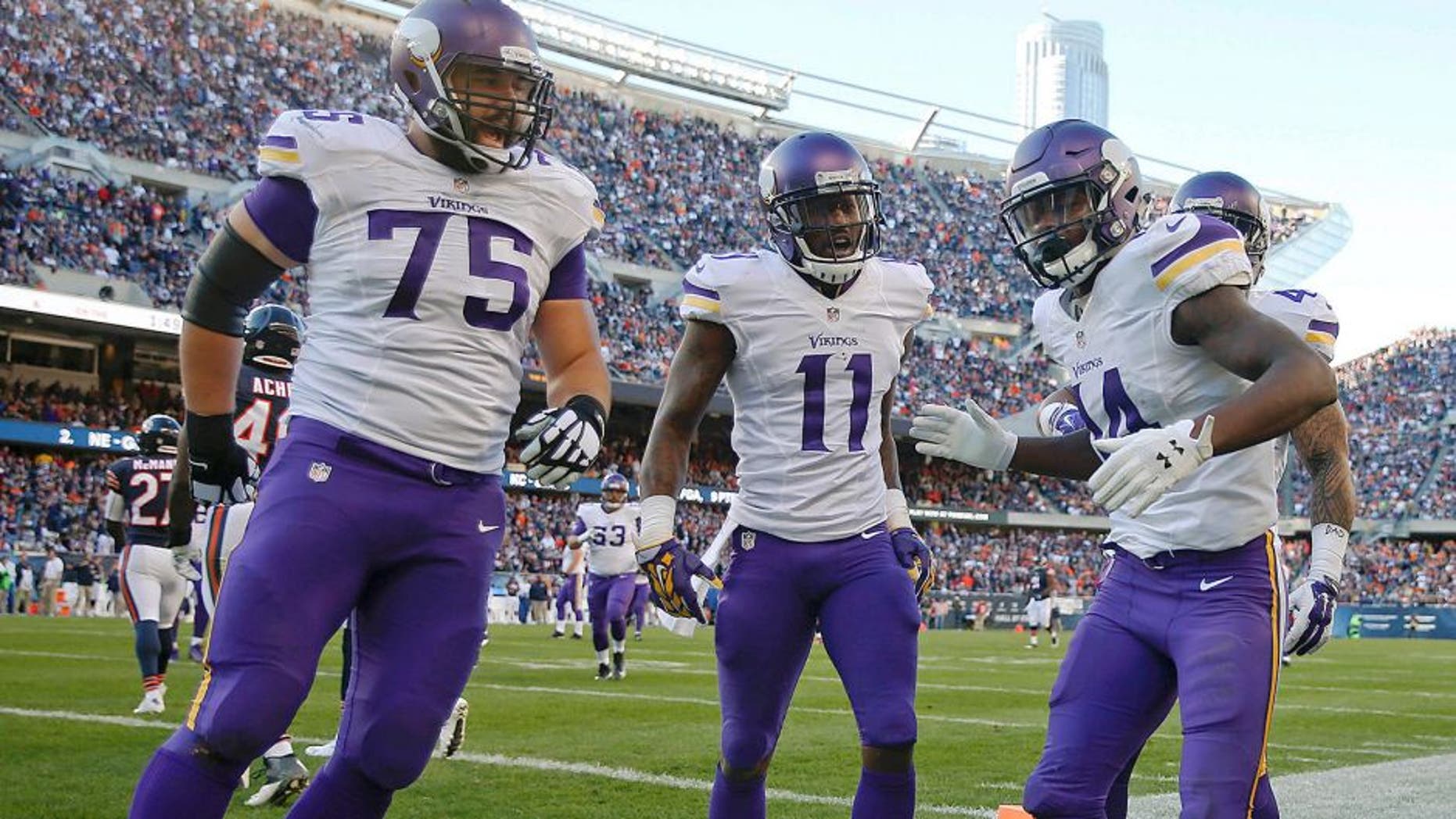 Nov 1, 2015; Chicago, IL, USA; Minnesota Vikings wide receiver Stefon Diggs (14) celebrates with teammates after scoring a touchdown against the Chicago Bears during the fourth quarter at Soldier Field. The Vikings won 23-20. Mandatory Credit: Kamil Krzaczynski-USA TODAY Sports