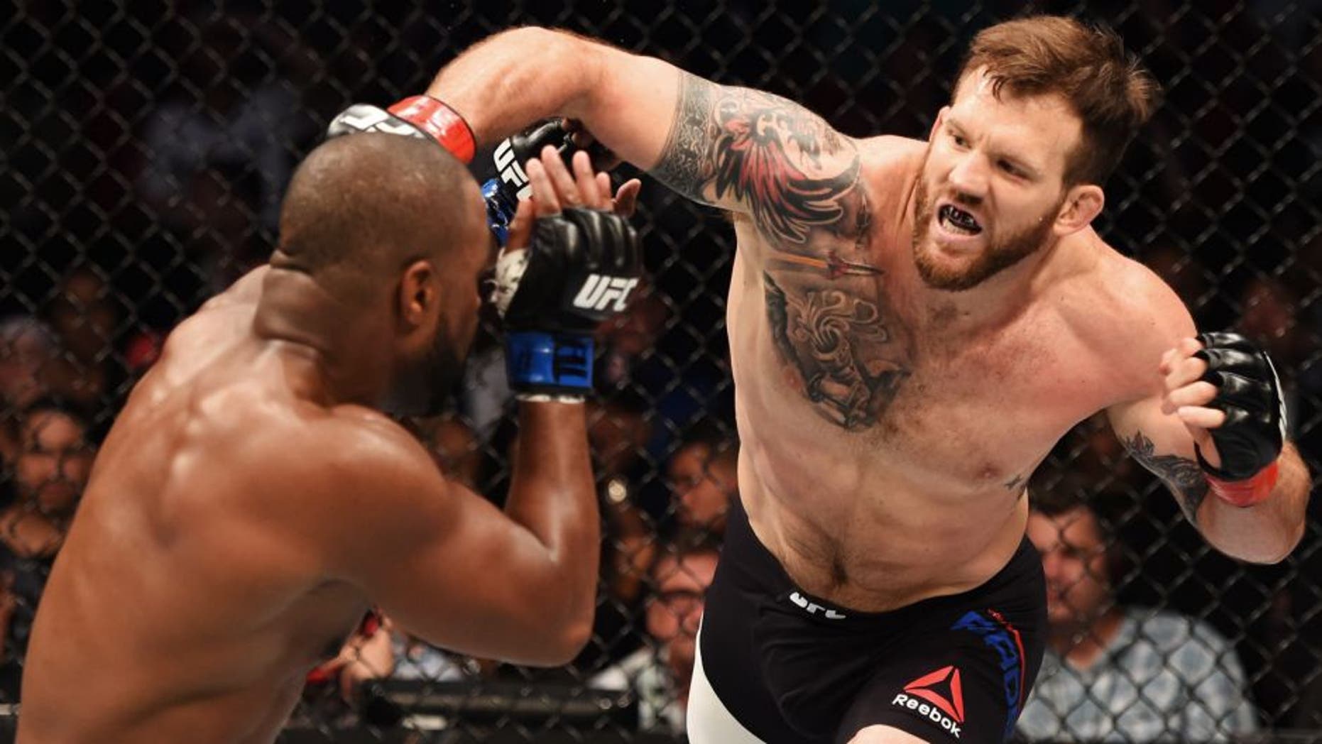 HOUSTON, TX - OCTOBER 03: (R-L) Ryan Bader punches Rashad Evans in their light heavyweight bout during the UFC 192 event at the Toyota Center on October 3, 2015 in Houston, Texas. (Photo by Josh Hedges/Zuffa LLC/Zuffa LLC via Getty Images)