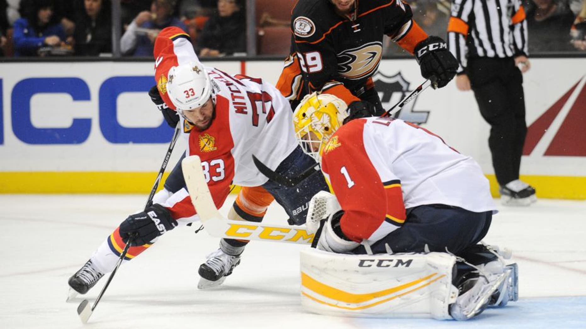 November 4, 2015; Anaheim, CA, USA; Florida Panthers defenseman Willie Mitchell (33) helps goalie Roberto Luongo (1) defend the goal against Anaheim Ducks right wing Chris Stewart (29) during the second period at Honda Center. Mandatory Credit: Gary A. Vasquez-USA TODAY Sports