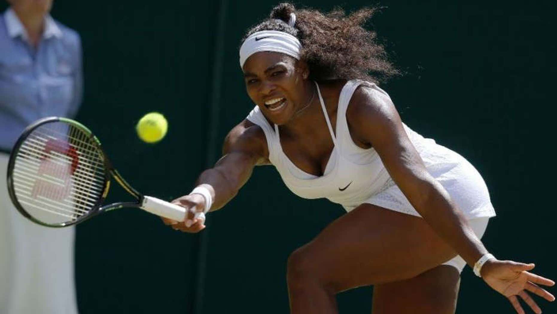 July 11, 2015: Serena Williams of the United States returns a shot to Garbine Muguruza of Spain, during the women's singles final at the All England Lawn Tennis Championships in Wimbledon, London.