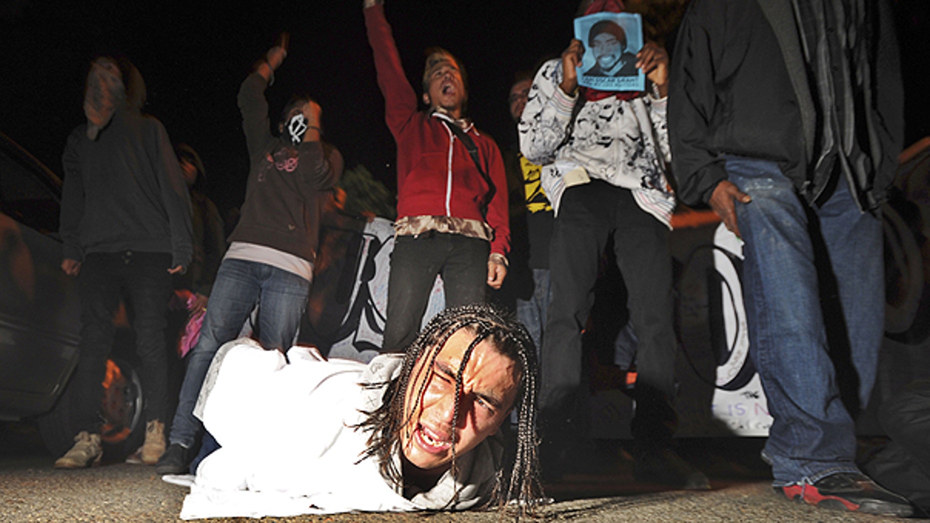 Nov. 5: A demonstrator lies on the ground during a protest after the sentencing of ormer Bay Area Rapid Transit police officer Johannes Mehserle.
