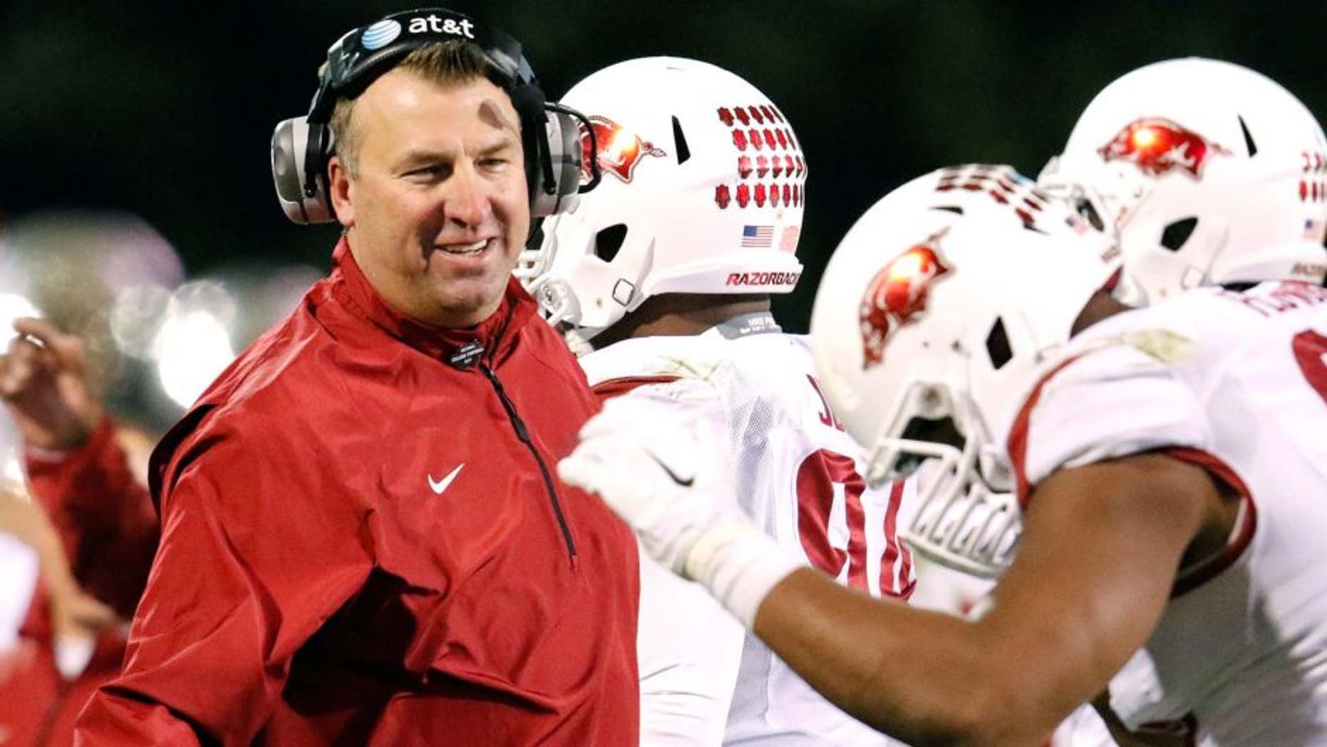 Nov 1, 2014; Starkville, MS, USA; Arkansas Razorbacks head coach Bret Bielema congratulates his players after a play during the game against the Mississippi State Bulldogs at Davis Wade Stadium. The Bulldogs defeat the Razorbacks 17-10. Mandatory Credit: Marvin Gentry-USA TODAY Sports
